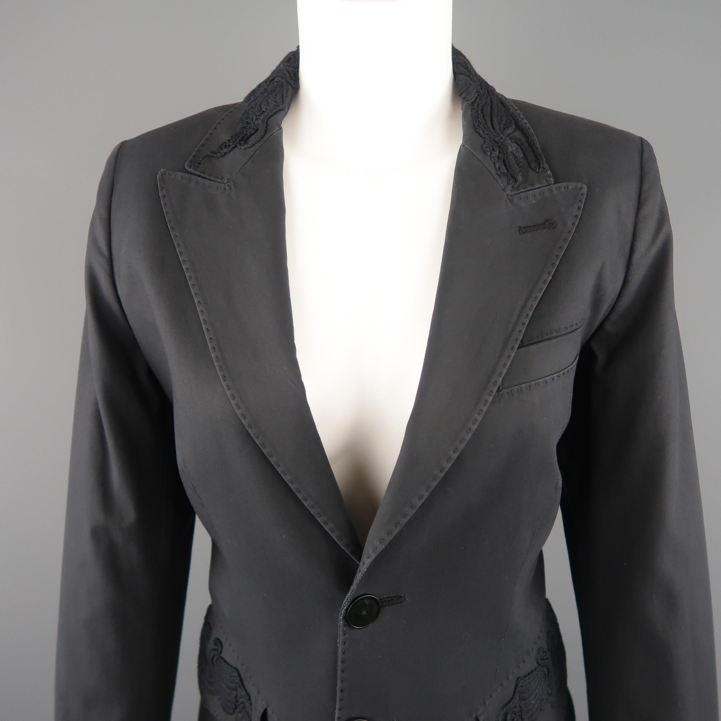 JEAN PAUL GAULTIER blazer jacket comes in dark gray cotton with a single breasted three button front, peak lapel, top stitching details throughout, functional button cuffs, detailed flap pockets, and embroidery accents. Wear throughout fabric.