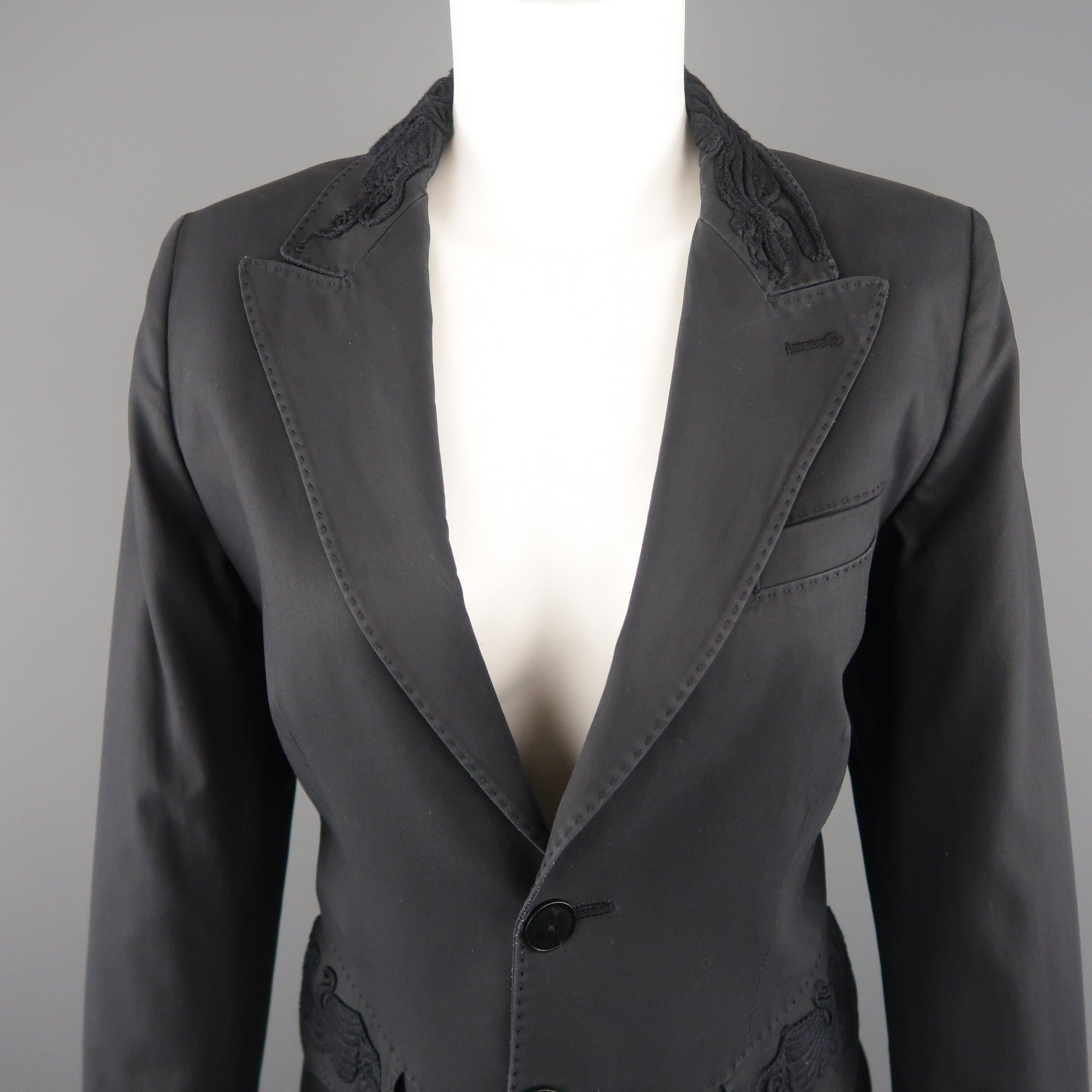 JEAN PAUL GAULTIER blazer jacket comes in dark gray cotton with a single breasted three button front, peak lapel, top stitching details throughout, functional button cuffs, detailed flap pockets, and embroidery accents. Wear. As-is. Made in
