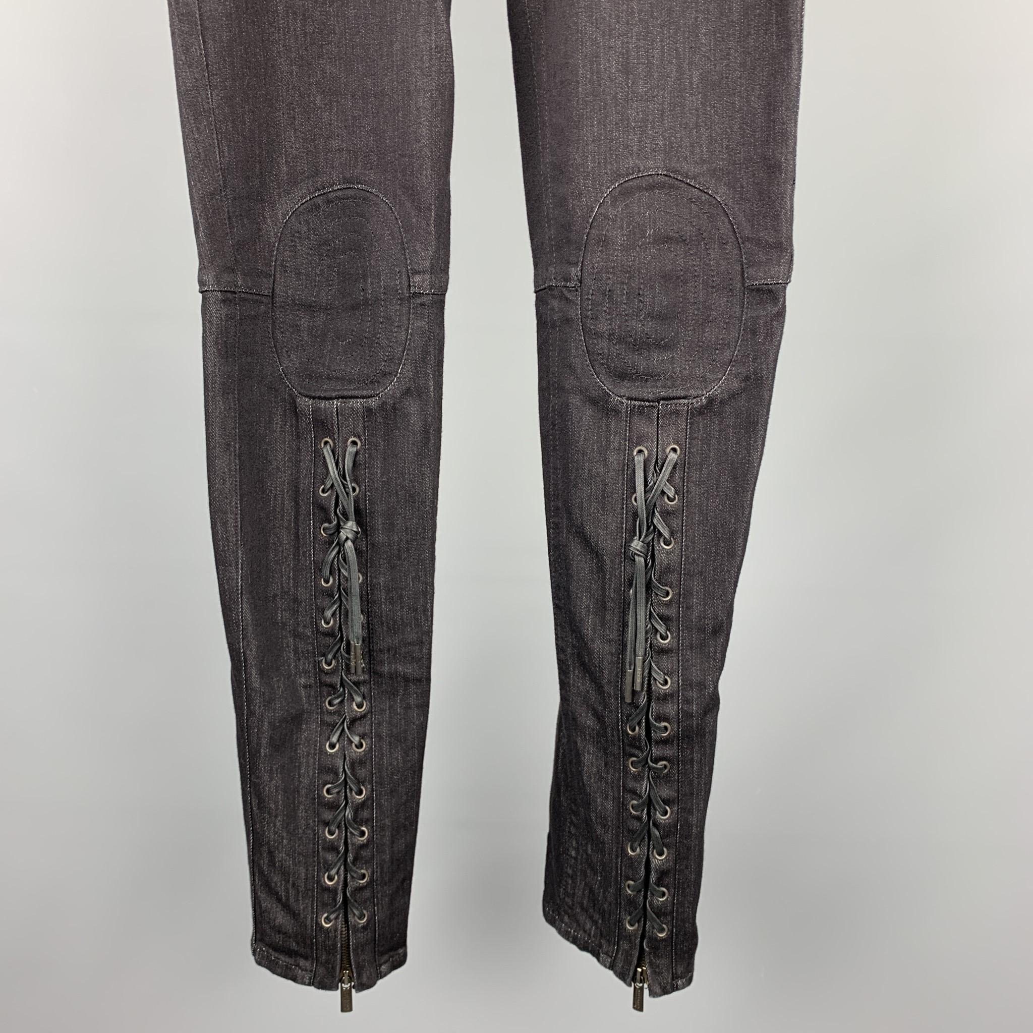 JEAN PAUL GAULTIER jeans comes in a black denim featuring a low rise style, zipper laced leg details, knee stitching, back pocket metal embellishment, and a zip fly closure. Made in Romania.

Excellent Pre-Owned Condition.
Marked: