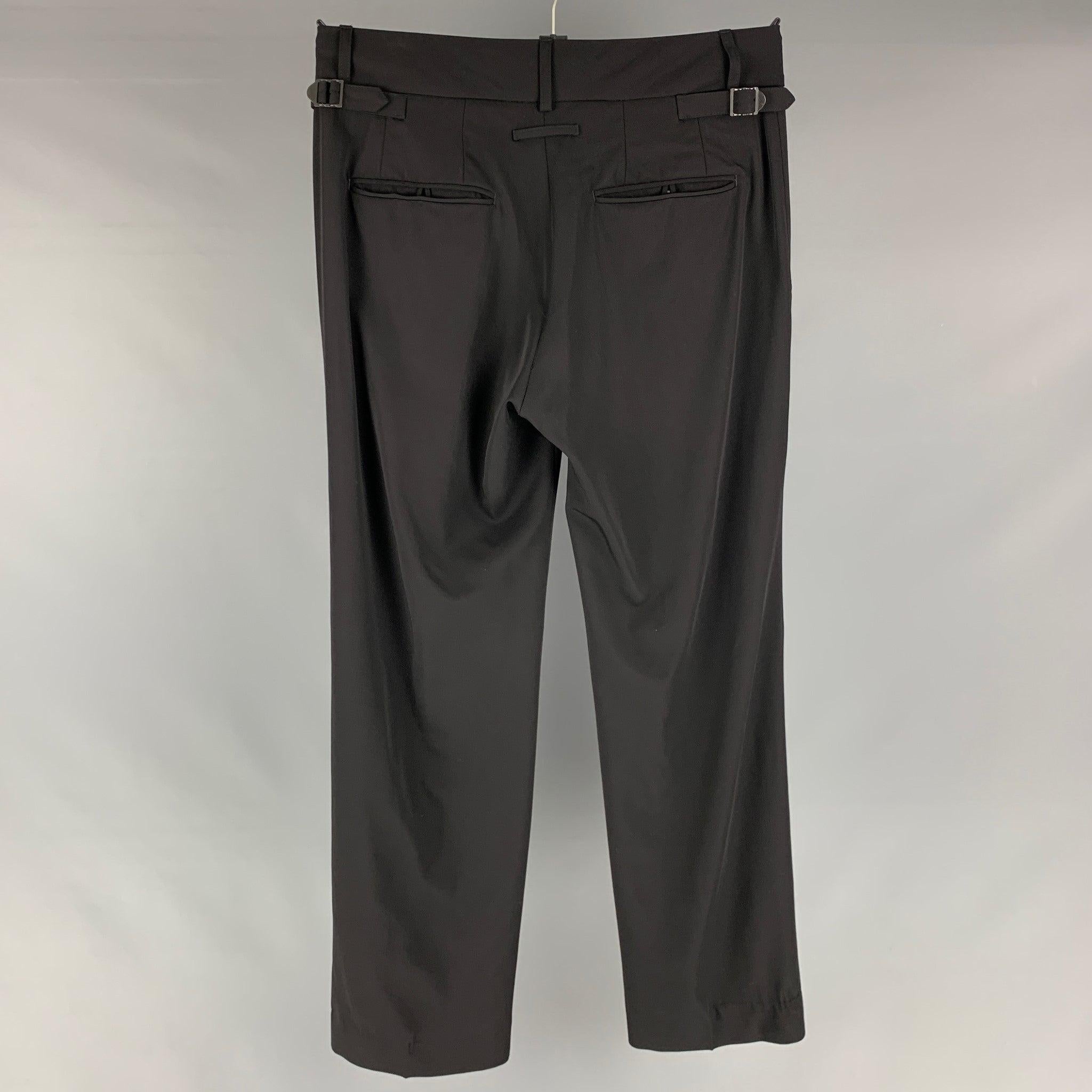 JEAN PAUL GAULTIER trousers comes in a black wool featuring side tabs and a button up closure. Made in Italy.Very Good Pre-Owned Condition. 

Marked:  32 

Measurements: 
 Waist: 32 inches Rise: 10 inches Inseam: 30 inches 
 

 
 
 
Reference: