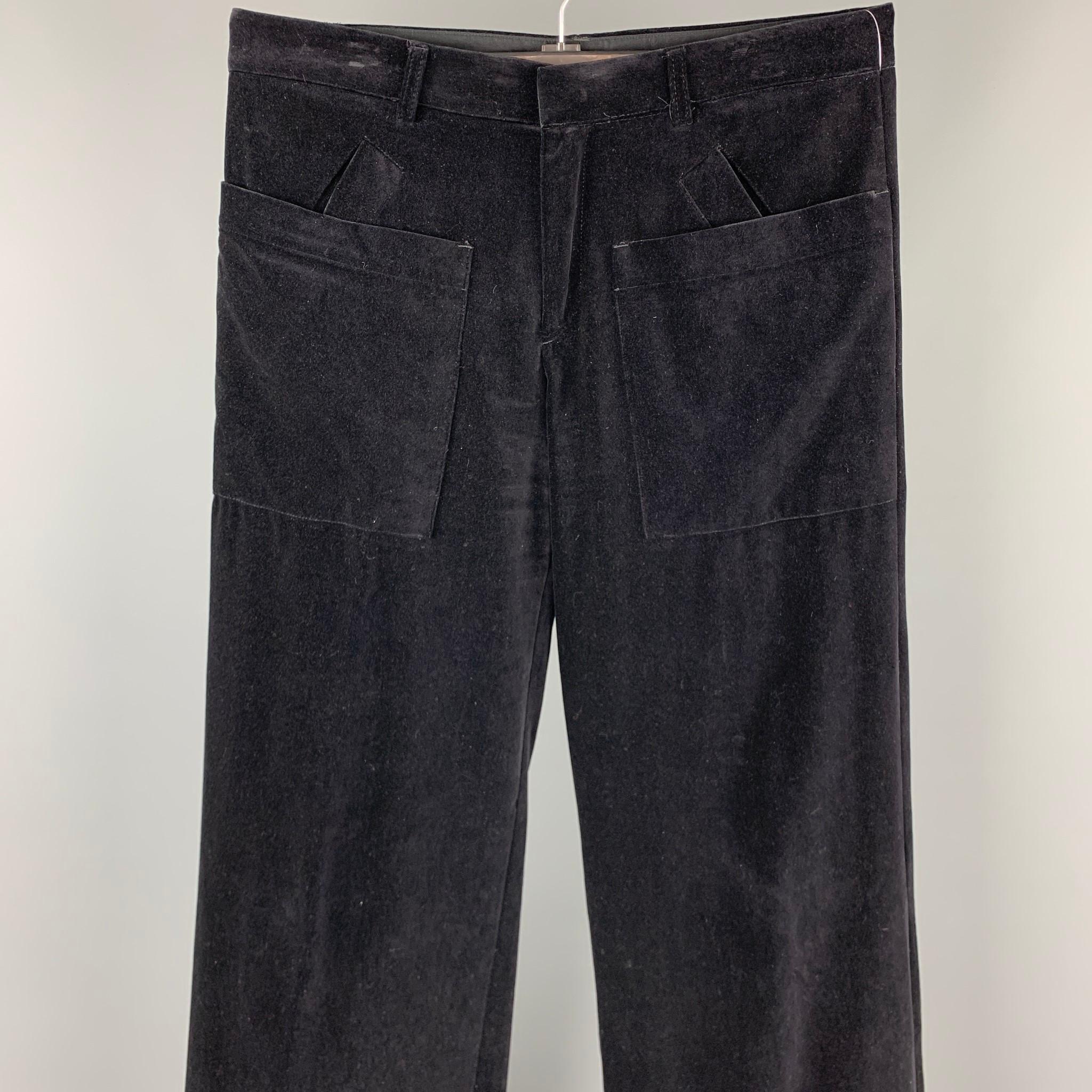 JEAN PAUL GAULTIER dress pants comes in a black cotton velvet featuring a wide leg style, front patch pockets, cuffed leg, and a zip fly closure. Made in Italy.

Very Good Pre-Owned Condition.
Marked: I 50 / E 50 / GB 40 / US