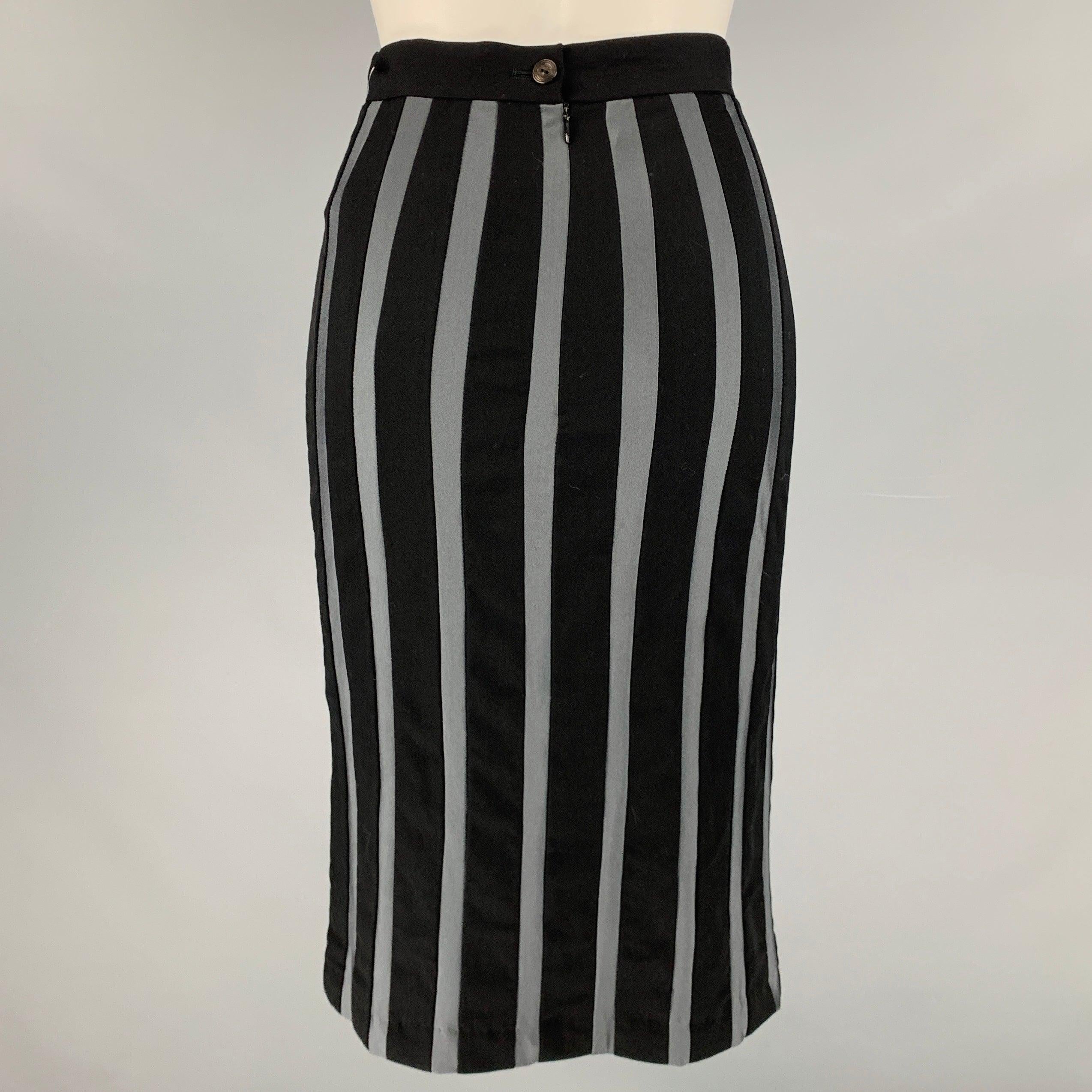 JEAN PAUL GAULTIER skirt
in a
black and grey fabric featuring a vertical stripe pattern, pencil style, and zipper closure.Very Good Pre-Owned Condition. Mark on front of skirt, and fabric tags removed. 

Marked:   40. 

Measurements: 
  Waist: 25