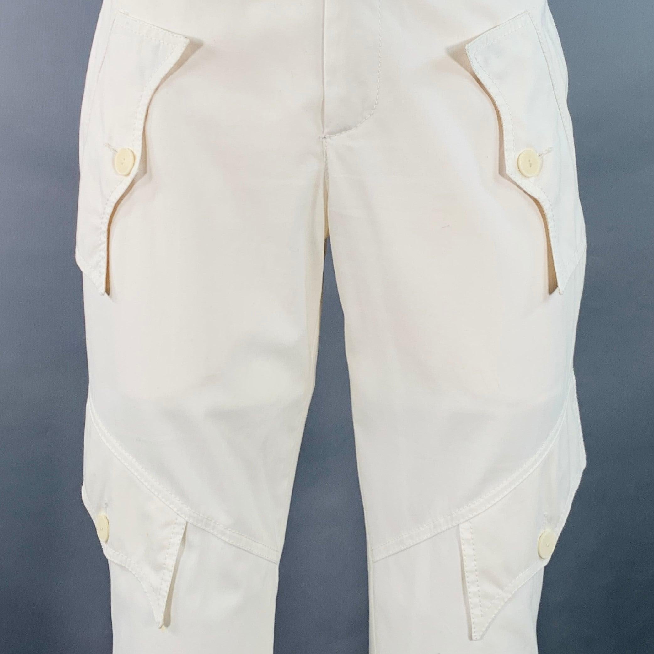 JEAN PAUL GAULTIER casual pants
in a cream cotton twill featuring a cargo style with multiple buttoned pockets, buttoned cuff with belt for adjustable cuff sizing, and zip fly closure. Made in Italy.Good Pre-Owned Condition. Multiple minor marks