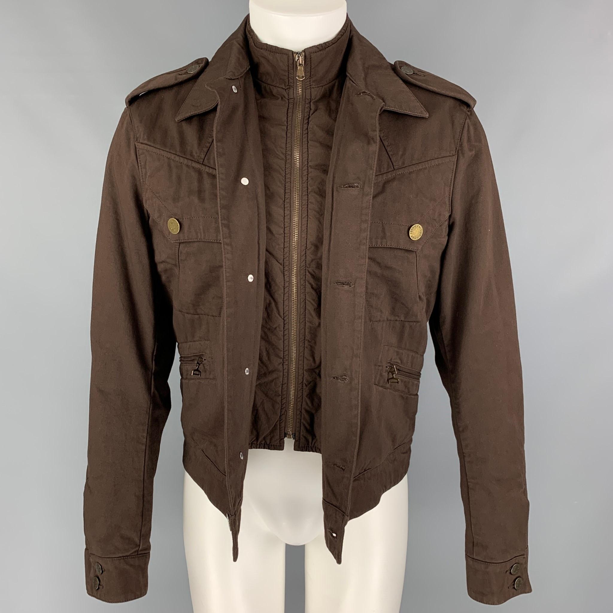 JEAN PAUL GAULTIER jacket comes in a brown material featuring a simulated vest, sailor back design, front pockets, epaulettes, zip up, and a buttoned closure. 

Very Good Pre-Owned Condition.
Marked: 50

Measurements:

Shoulder: 19 in.
Chest: 40
