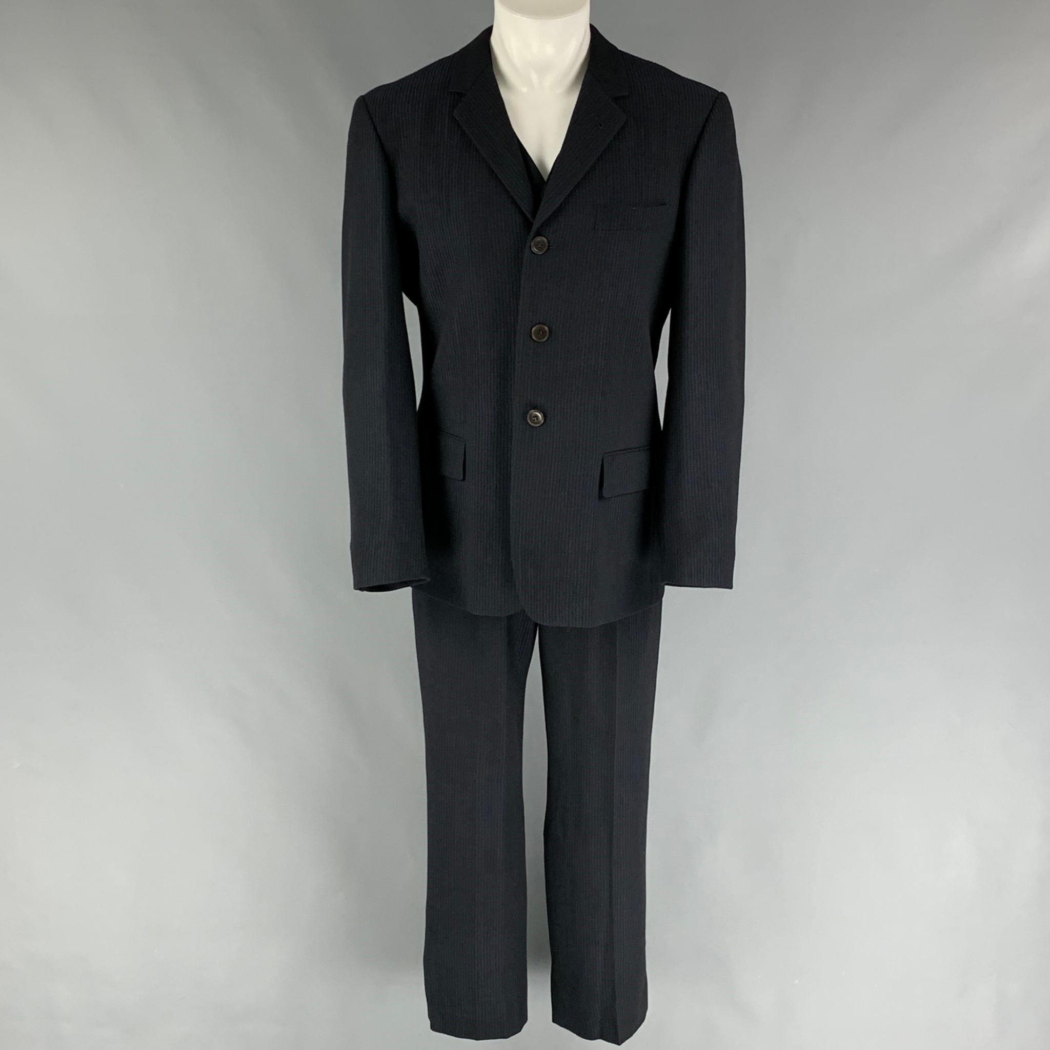 JEAN PAUL GAULTIER suit comes in a navy & black stripe wool featuring a jumpsuit style, flap pockets, zip fly closure, and a matching blazer. Made in Italy. 

Very Good Pre-Owned Condition.
Marked: I 50 / E 50 / GB 40 / USA 40

Measurements:

