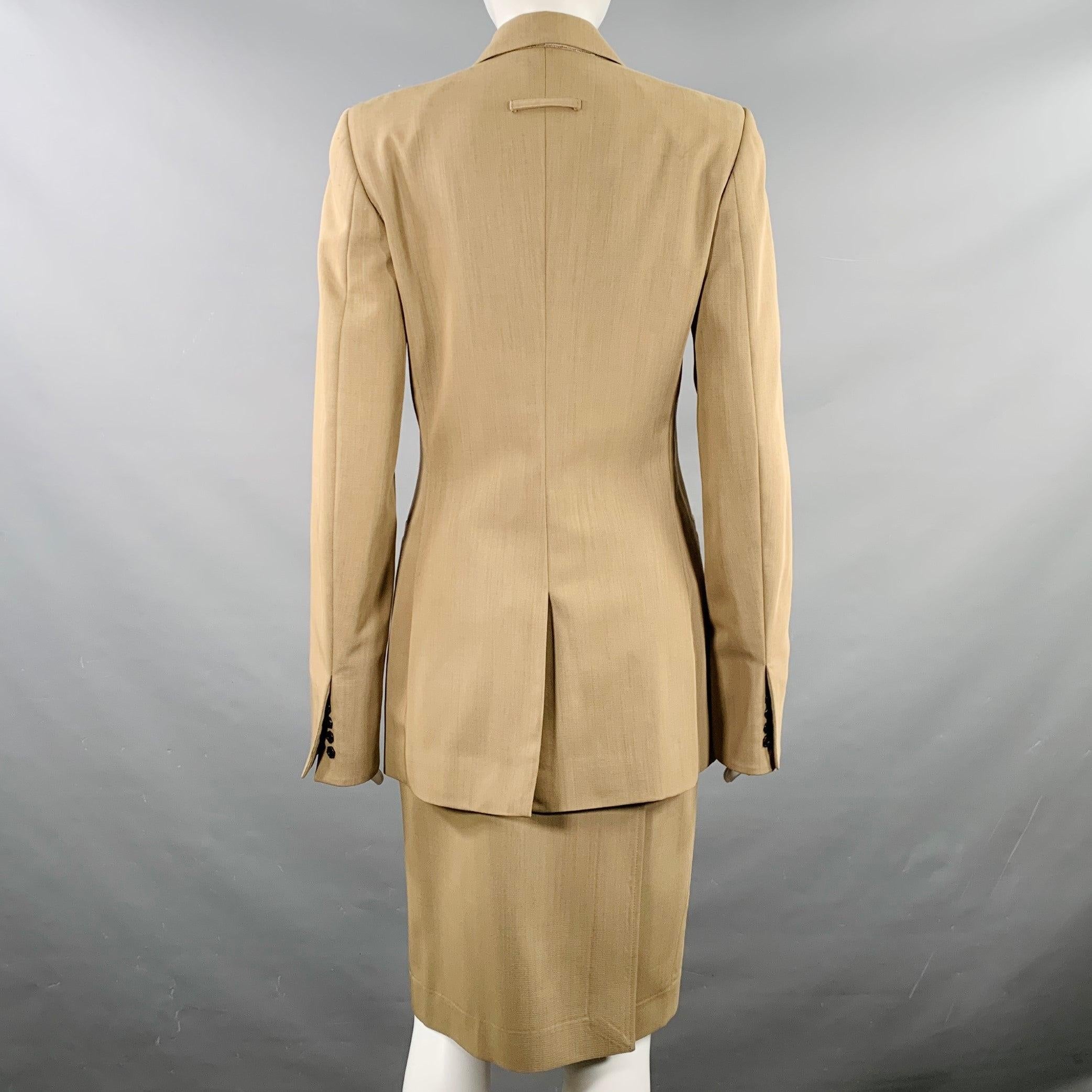 JEAN PAUL GAULTIER skirt suit
in a beige wool and includes a snap closure single breasted jacket with shoulder pads, and a matching pencil skirt. Made in Italy.Very Good Pre-Owned Condition. Minor marks under arms which cannot be seen when worn,