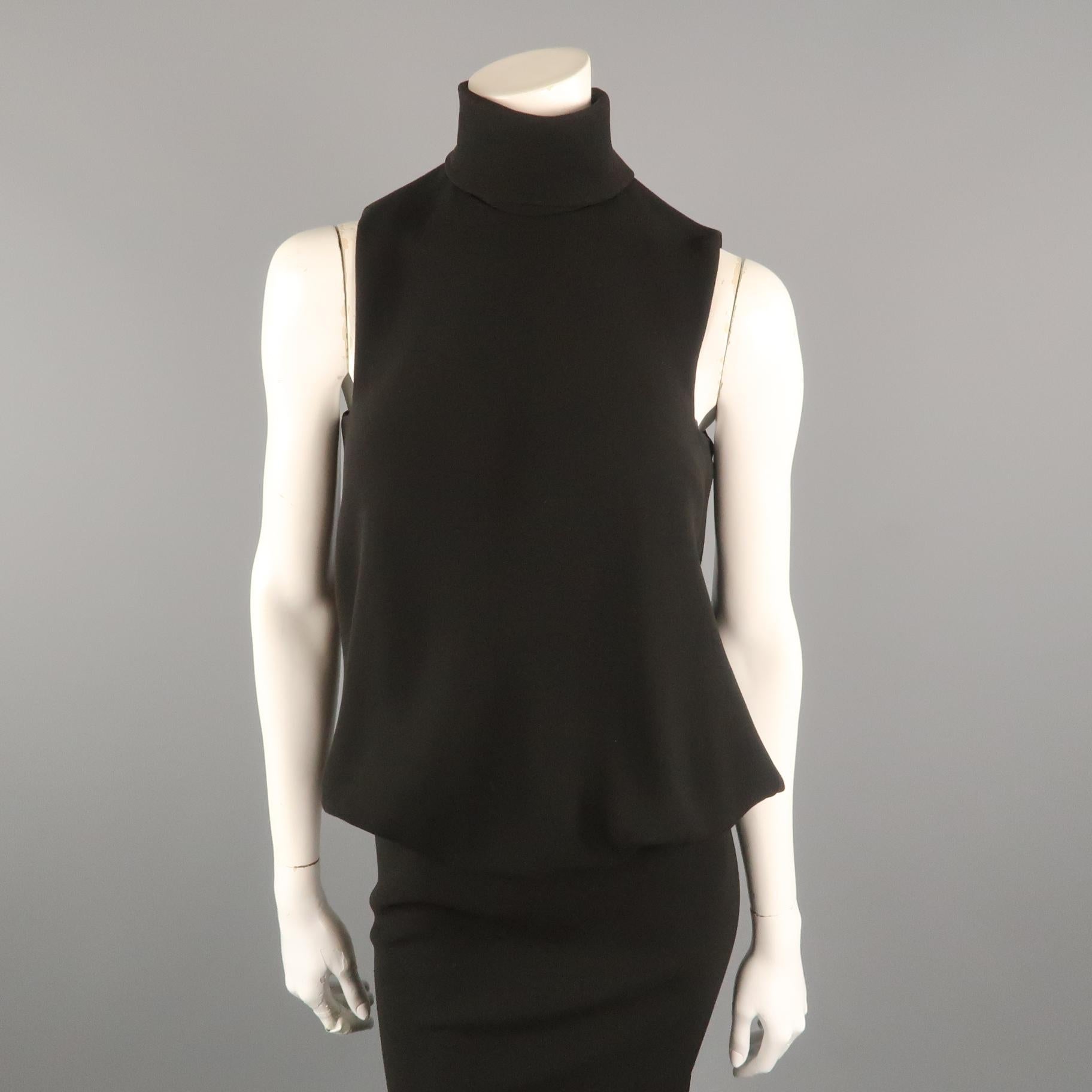 This fabulous archive JEAN PAUL GAULTIER evening dress comes in black crepe with a fold over high turtleneck, sleeveless top with bubble hem flounce over waistline, open slit back, and long pencil skirt with flaired hem. Made in Italy.
 
Excellent
