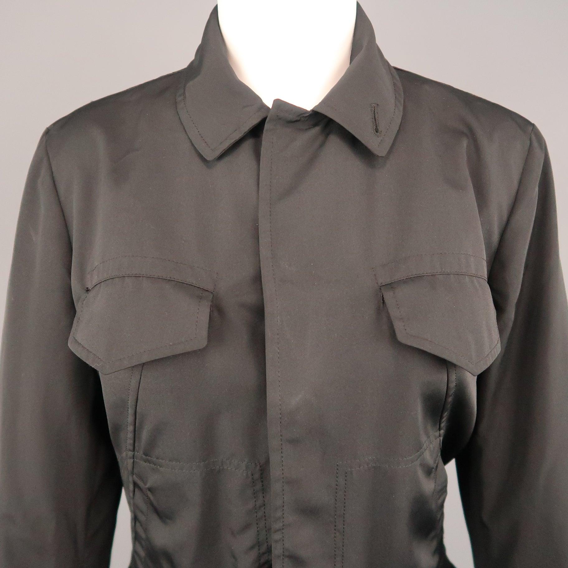 Vintage JEAN PAUL GAULTIER trucker style jacket comes in black fabric with a pointed collar, hidden placket snap closure, flap and slit pockets, and detachable brown leather belt waistband. Made in Italy.Excellent Pre-Owned Condition. 

Marked:   8