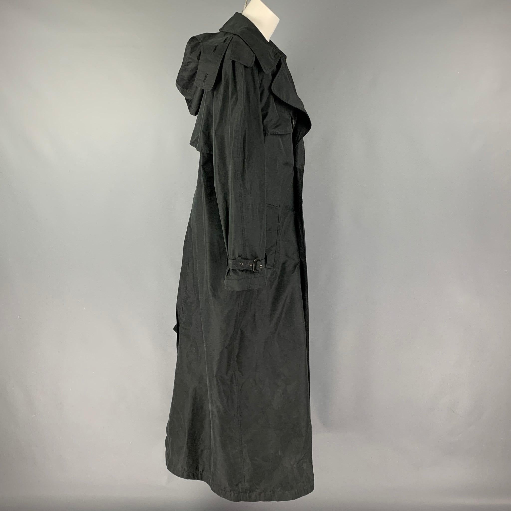 JEAN PAUL GAULTIER coat comes in a black polyester / silk featuring a large lapel, slit pockets, belted sleeve details, hooded, and a double breasted closure. Missing Belt. Made in Italy.
Very Good
Pre-Owned Condition. 

Marked:  I 42 / D 38 / F 38