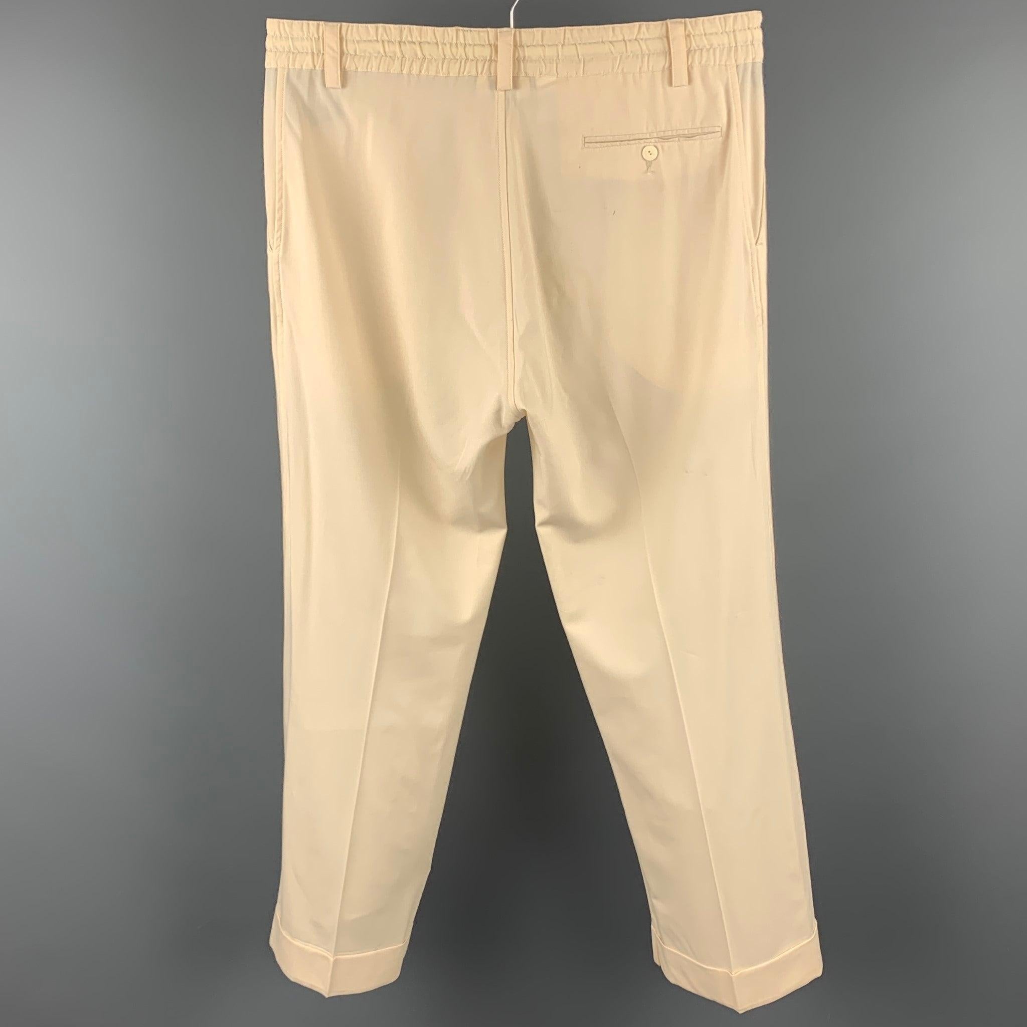 JEAN PAUL GAULTIER casual pants comes in a cream wool blend featuring a straight leg, drawstring, slit pockets, cuffed leg, and a button fly closure. Moderate wear. Made in Italy.Good
 Pre-Owned Condition. 
 

 Marked:  M 
 

 Measurements: 
 