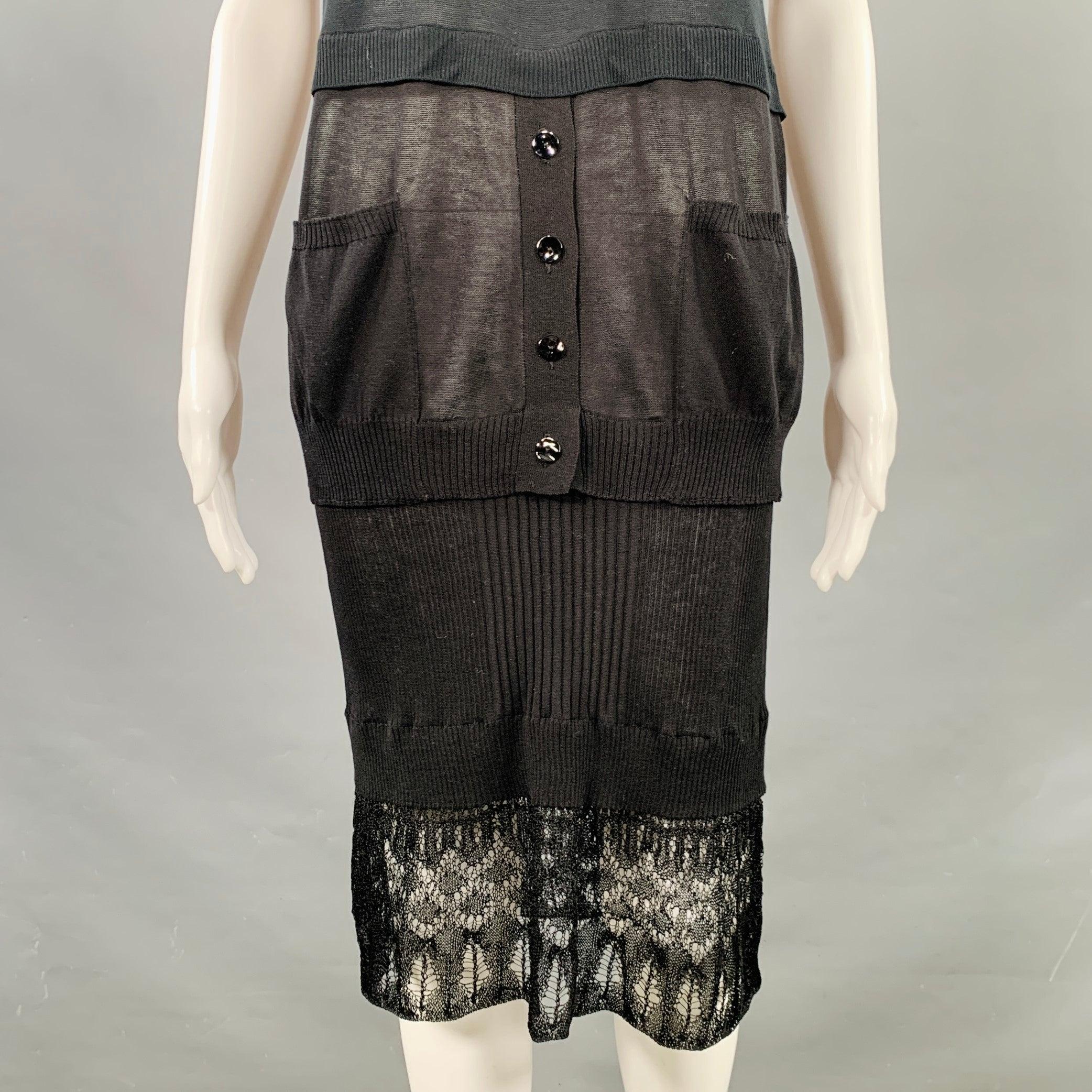 JEAN PAUL GAULTIER dress
in a
black jersey fabric featuring a cowl neck, short sleeves, and layered skirt with mixed knit and crochet patterns. Made in Italy.Excellent Pre-Owned Condition. 

Marked:   S 

Measurements: 
 
Shoulder: 15.5 inches Bust