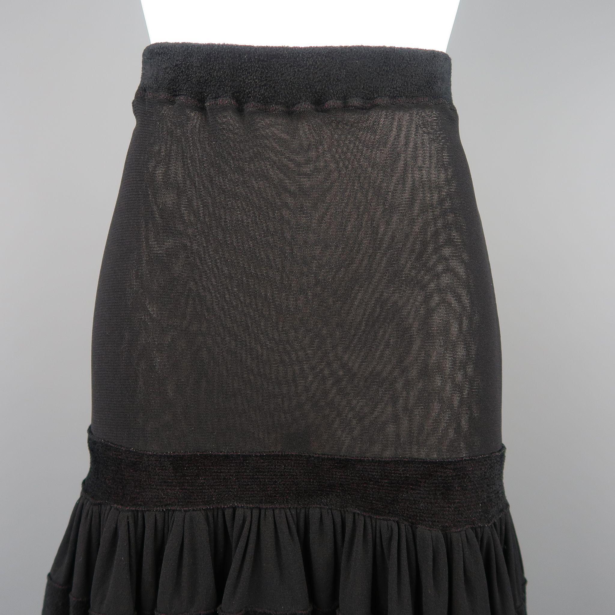 JEAN PAUL GAULTIER skirt comes in stretch micro mesh and features a fitted pencil top, drop waist, ruffle flair skirt, and thick velour trim. Made in Italy.
 
Good Pre-Owned Condition.
Marked: S

Measurements:

Waist: 23 in.
Hip: 32 in.
Length: 27