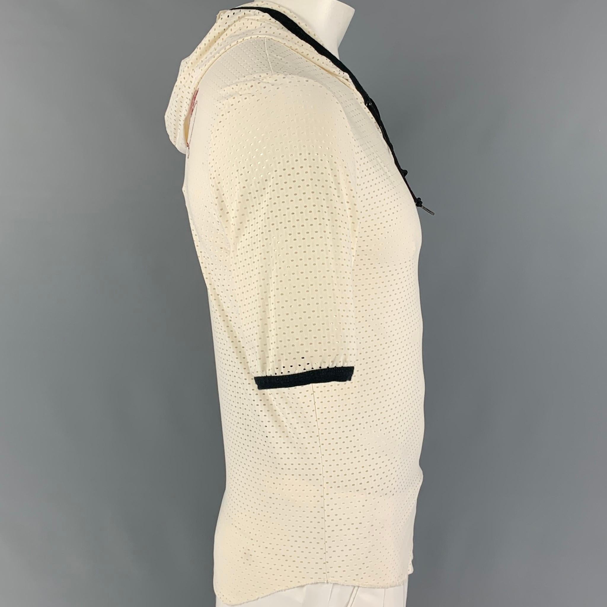 JEAN PAUL GAULTIER pullover comes in a cream perforated material featuring a hooded style, black trim,back print design, and a front self-tie design. Made in Italy. 

Very Good Pre-Owned Condition.
Marked: XL

Measurements:

Shoulder: 18 in.
Chest: