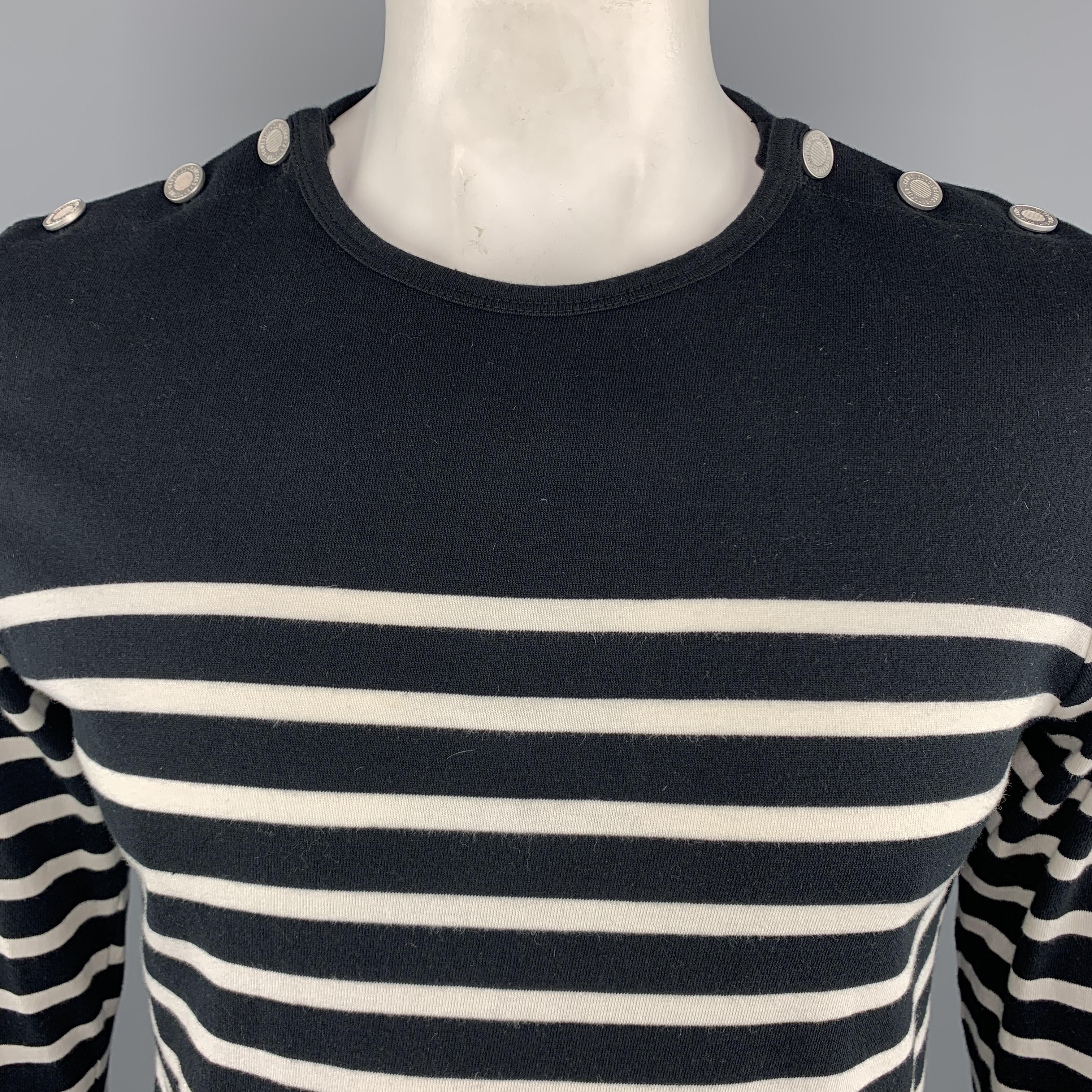 JEAN PAUL GAULTIER for OPENING CEREMONY / MATELOT Pullover Sweater comes in navy and white tones in a striped cotton material, with a buttoned collar, silver tone metal buttons and long sleeves.
 
Excellent Pre-Owned Condition.
Marked: L
