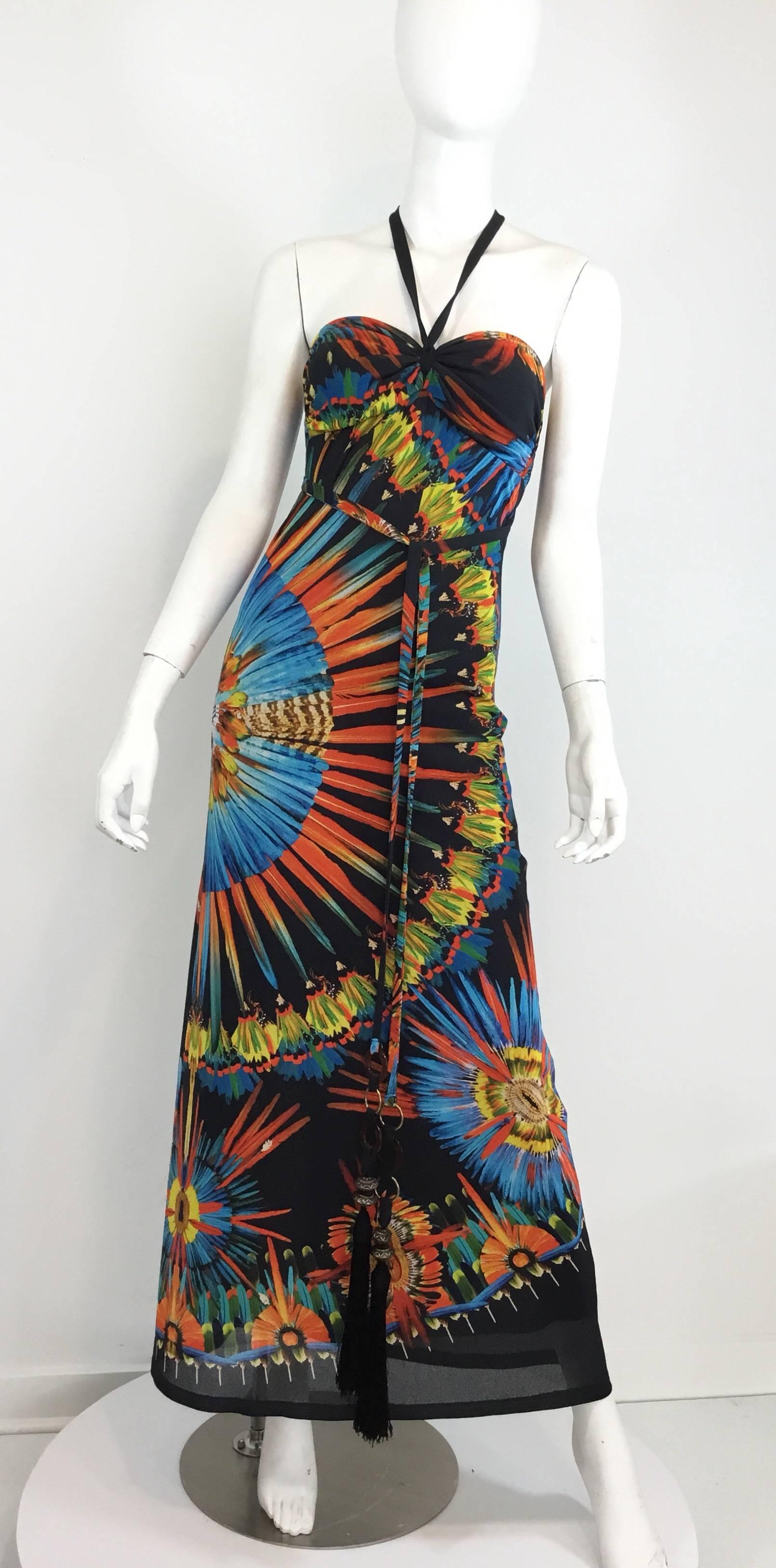 Jean Paul Gaultier maxi dress featured a bright and colorful print, halter style with a long tassel & tortoise disk string tie closure that can be worn multiple ways. Very light weight stocking knit. Dress is labeled a size S.

Garment has