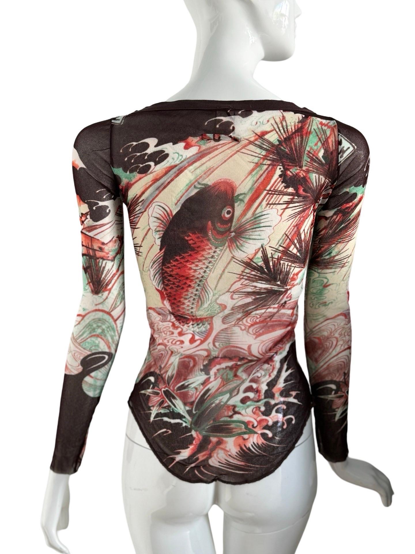 Highly sought after JPG Soleil mesh long sleeved top in a Koi fish tattoo print.  This top's design is in red and brown and soft green detailing and is in excellent condition with no flaws to note.  

The size is a M but the stretchy fabric allows