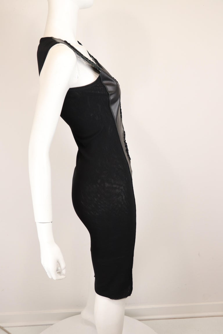 Jean Paul Gaultier Soleil fitted body concious black sheath dress with a black leather front panel and 3 layer stocking knit back panel. Leather front has open twisted and knotted leather work. Designed by Jean Paul Gaultier for Jean Paul Gaultier