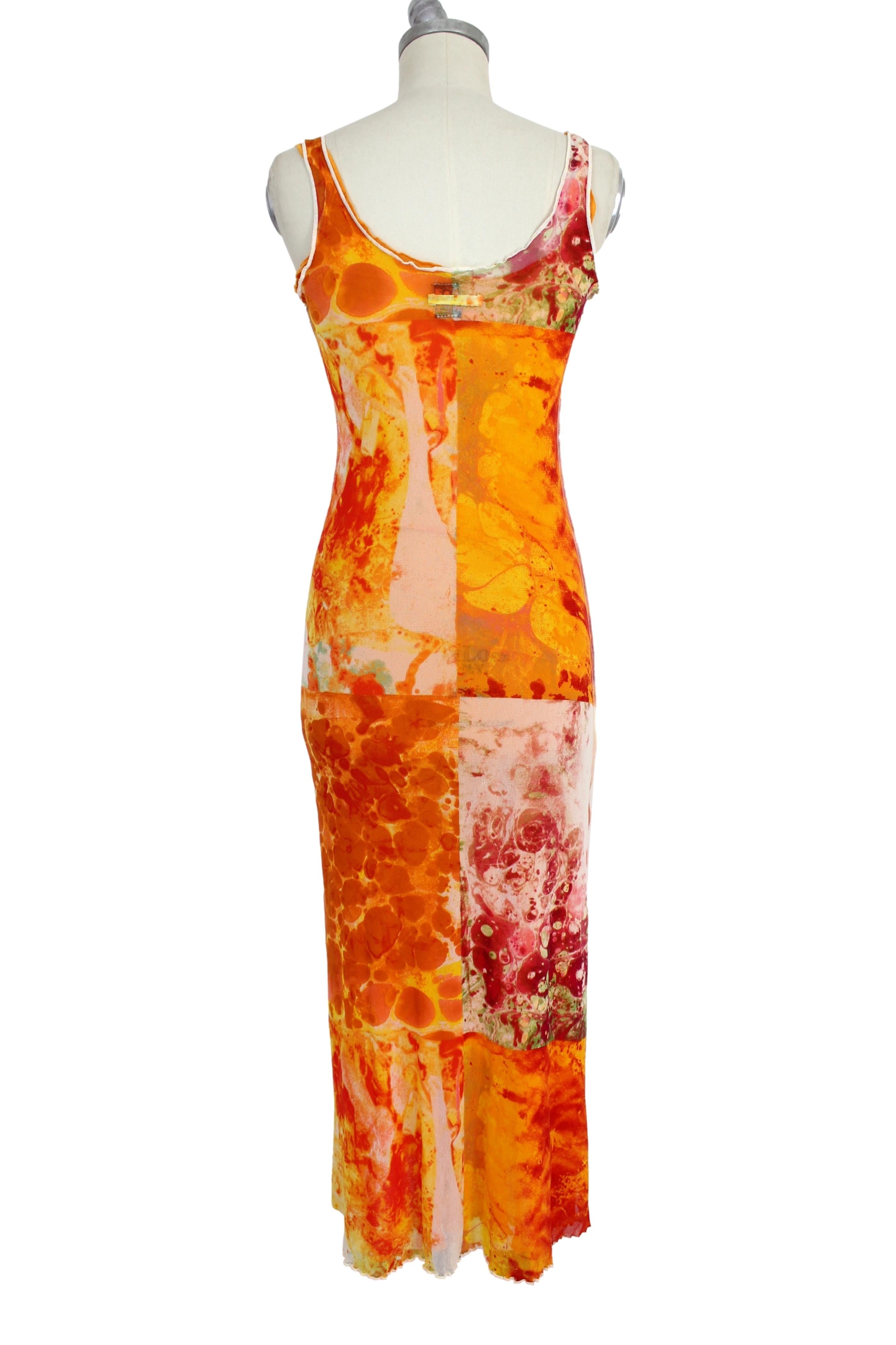 Jean Paul Gaultier Soleil vintage 90s dress. Long dress, fitted model. The dress consists of an orange petticoat and an orange transparent dress with floral designs in shades of green and pink. Polyester fabric. Made in Italy.

Condition: