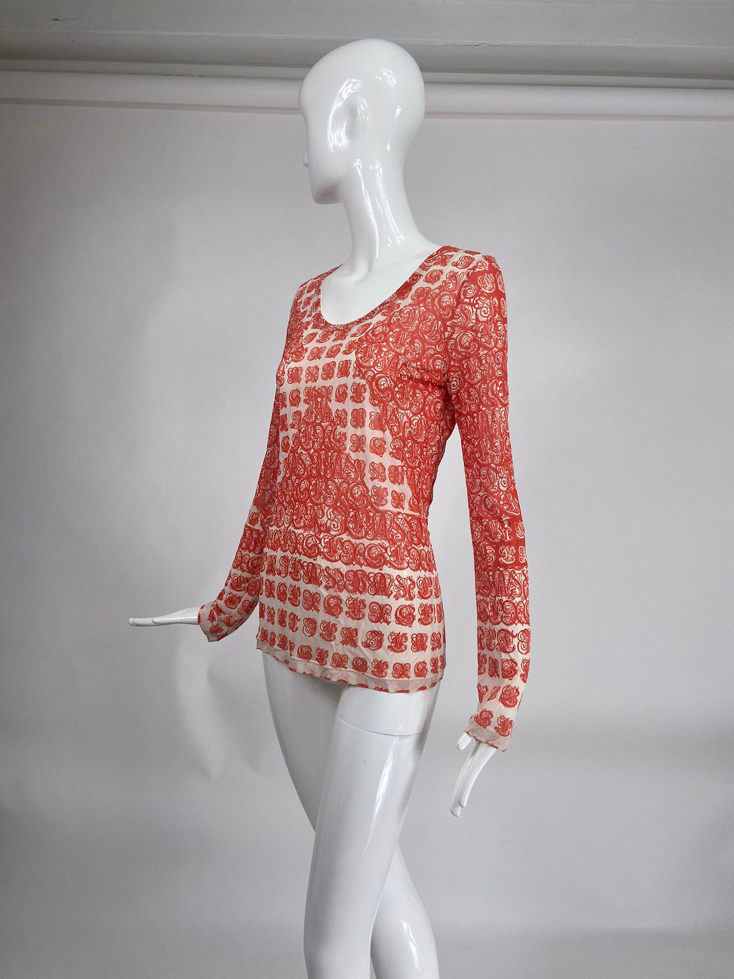 Jean Paul Gaultier Soleil, orange & white mesh gothic script lettering print top marked size Large. Pull on top with long sleeves and scoop neckline. Gothic alphabet print. 
       In excellent wearable condition.  All our clothing is dry cleaned