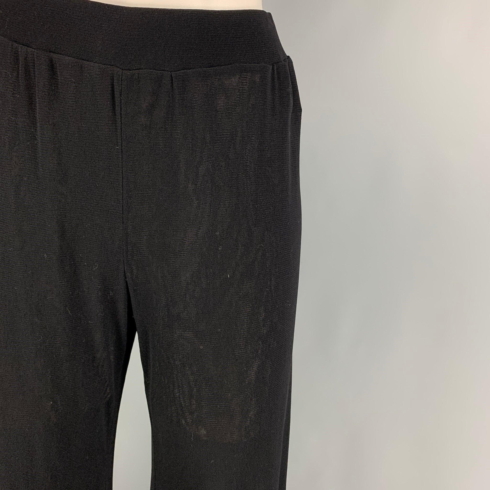 JEAN PAUL GAULTIER 'SOLEIL' pants comes in a black mesh nylon featuring a elastic waist and elastic cuffs. Made in Italy.
Very Good
Pre-Owned Condition. 

Marked:   L  

Measurements: 
  Waist: 28 inches  Rise: 12 inches  Inseam: 31 inches 
  
  
