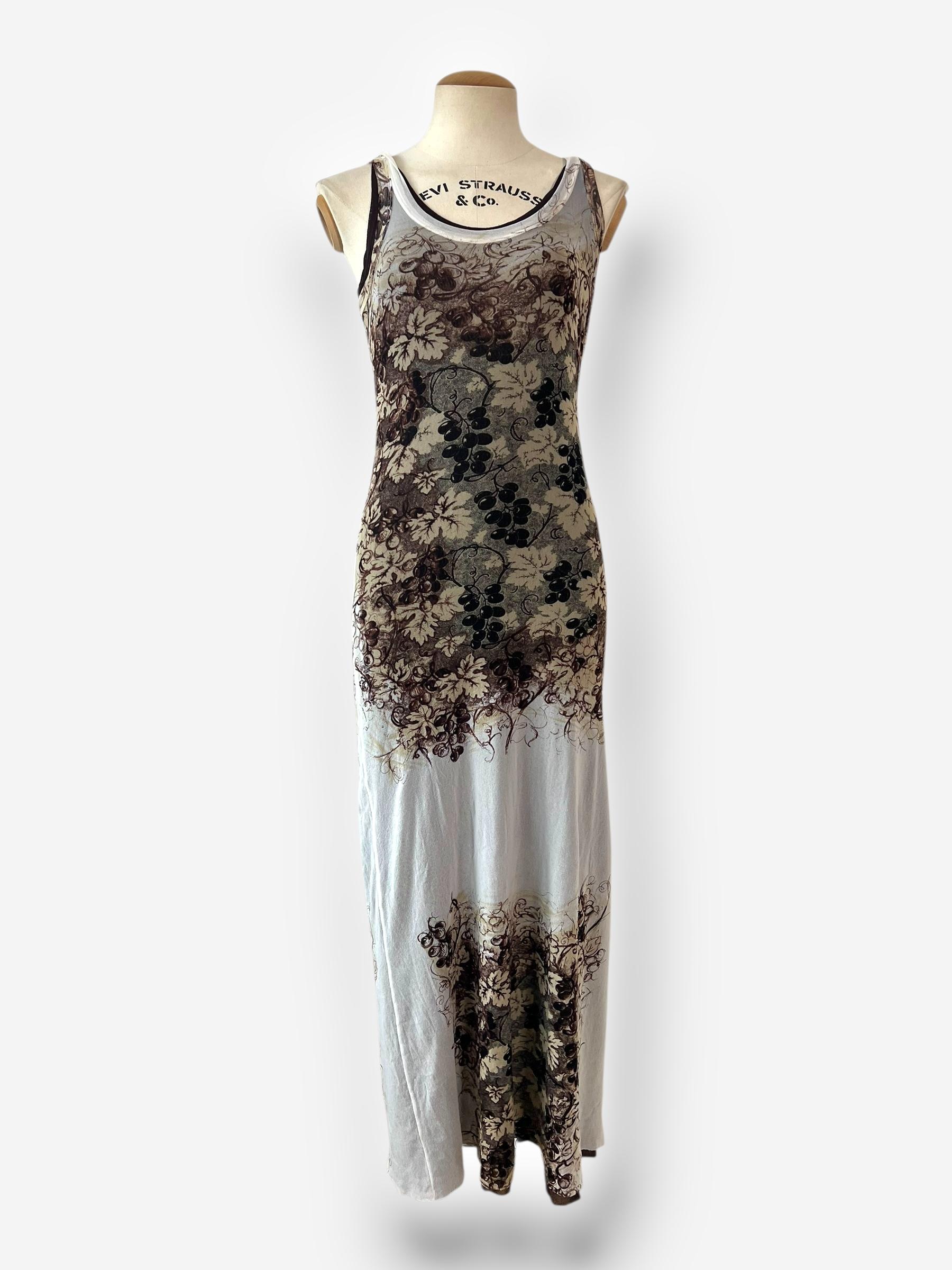This iconic Jean Paul Gaultier dress from the Spring/Summer 1999 collection features a sophisticated layered design with a delicate mesh outer layer and a fitted brown underdress for coverage and contrast. The intricate grapevine and foliage print