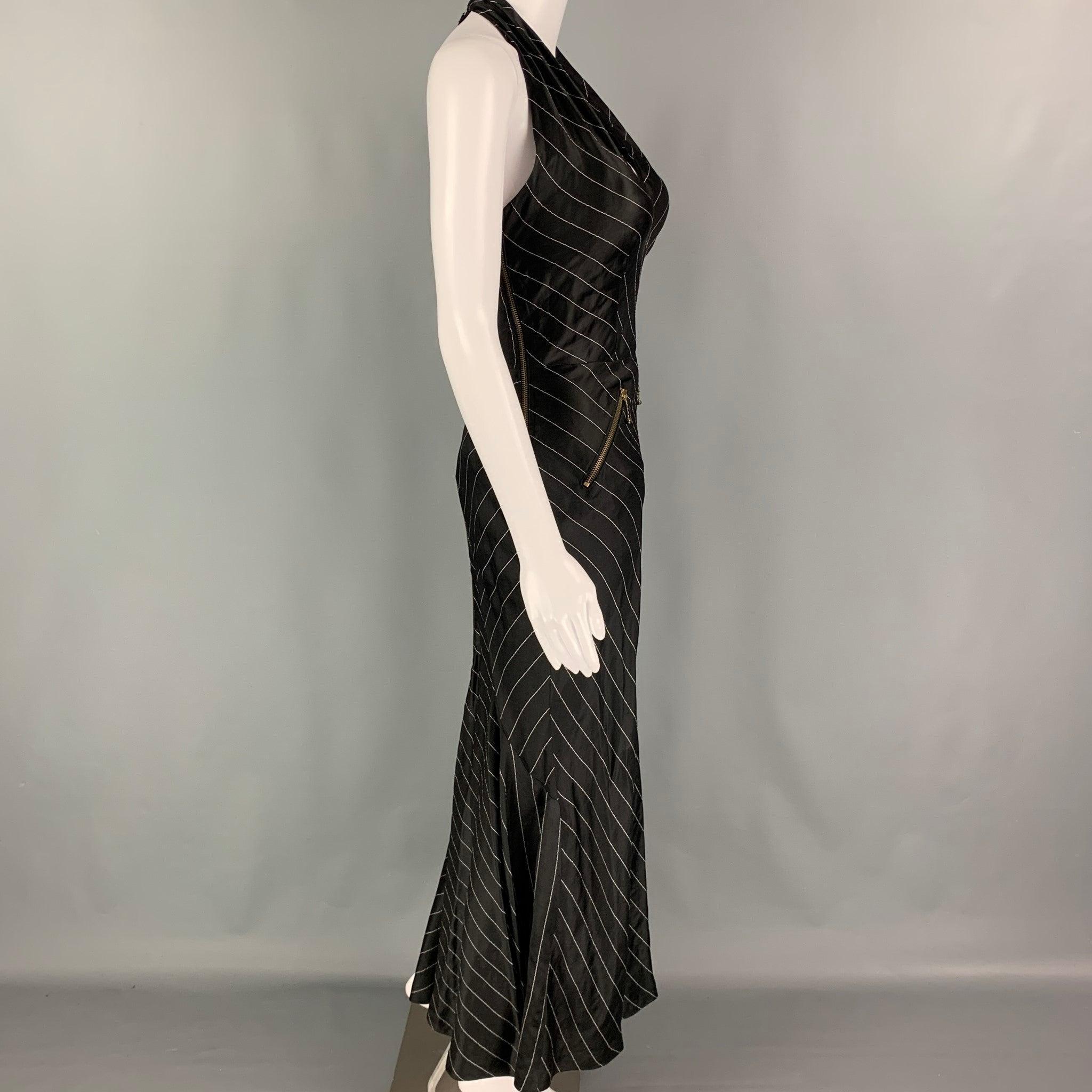 JEAN PAUL GAULTIER SS 1995 dress comes in a black & white pinstripe acetate blend featuring a open back, padded bust, zipper details, and a back zipper closure. Made in Italy.
Very Good Pre-Owned Condition. 

Marked:   40 

Measurements: 
  Bust: 28