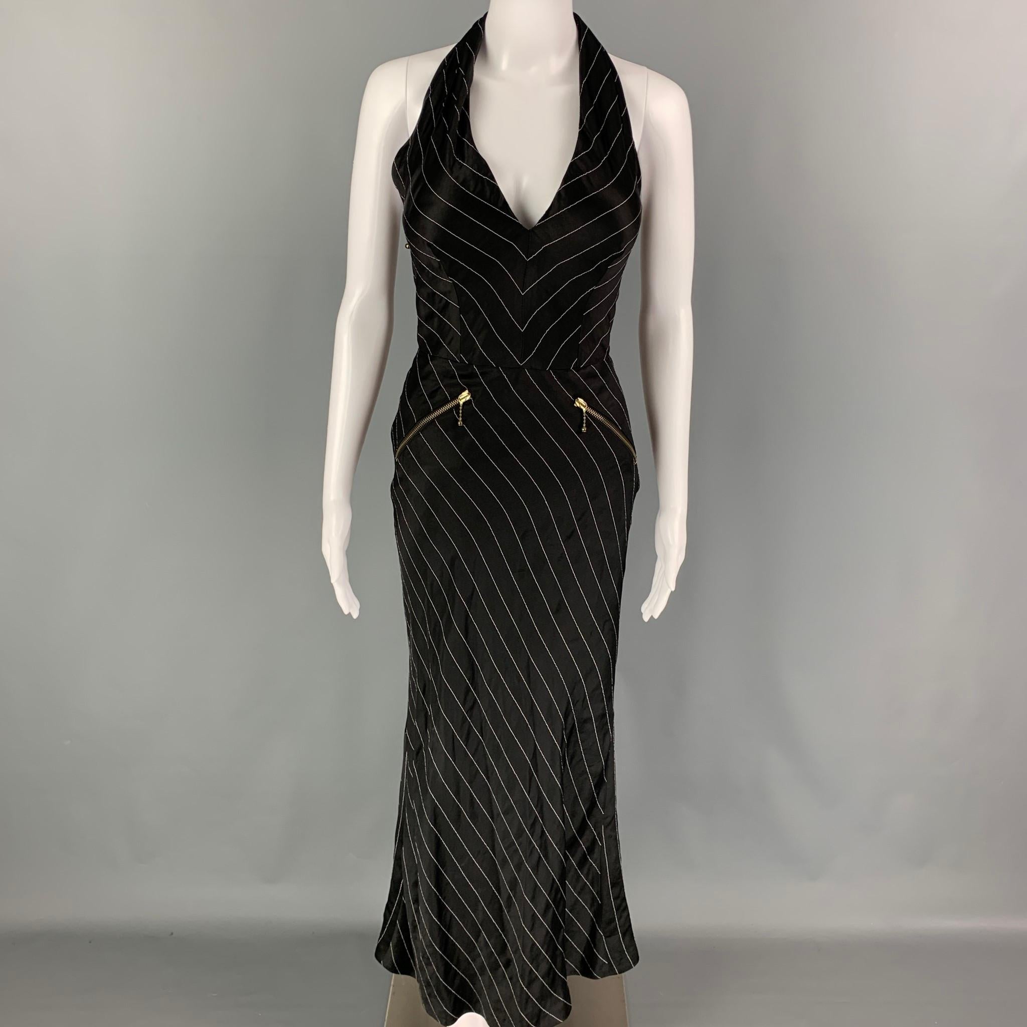 JEAN PAUL GAULTIER SS 1995 dress comes in a black & white pinstripe acetate blend featuring a open back, padded bust, zipper details, and a back zipper closure. Made in Italy. 

Very Good Pre-Owned Condition.
Marked: 40

Measurements:

Bust: 28