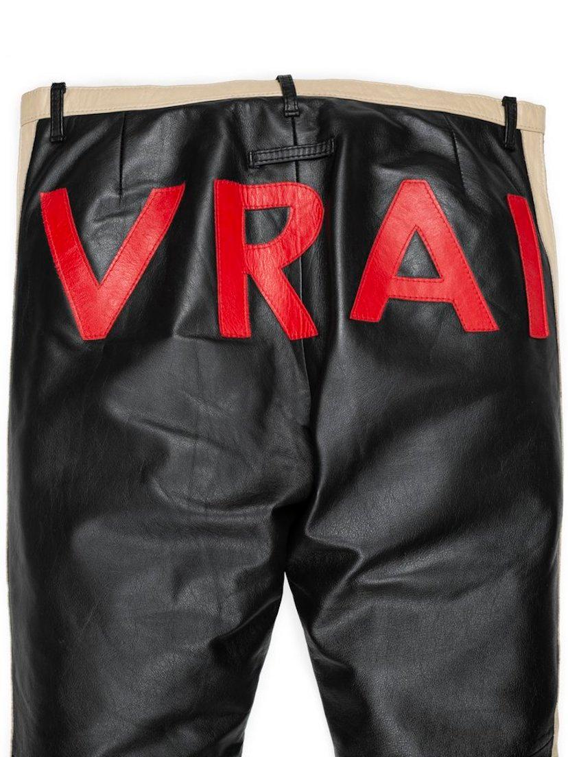 The word “vrai” — French for “true” — appeared on a litany of garments from Jean Paul Gaultier’s spring 2002 collection. It was seen on delicate appliqués atop mesh dresses and tops, and most famously on the back of leather track jackets and pants.