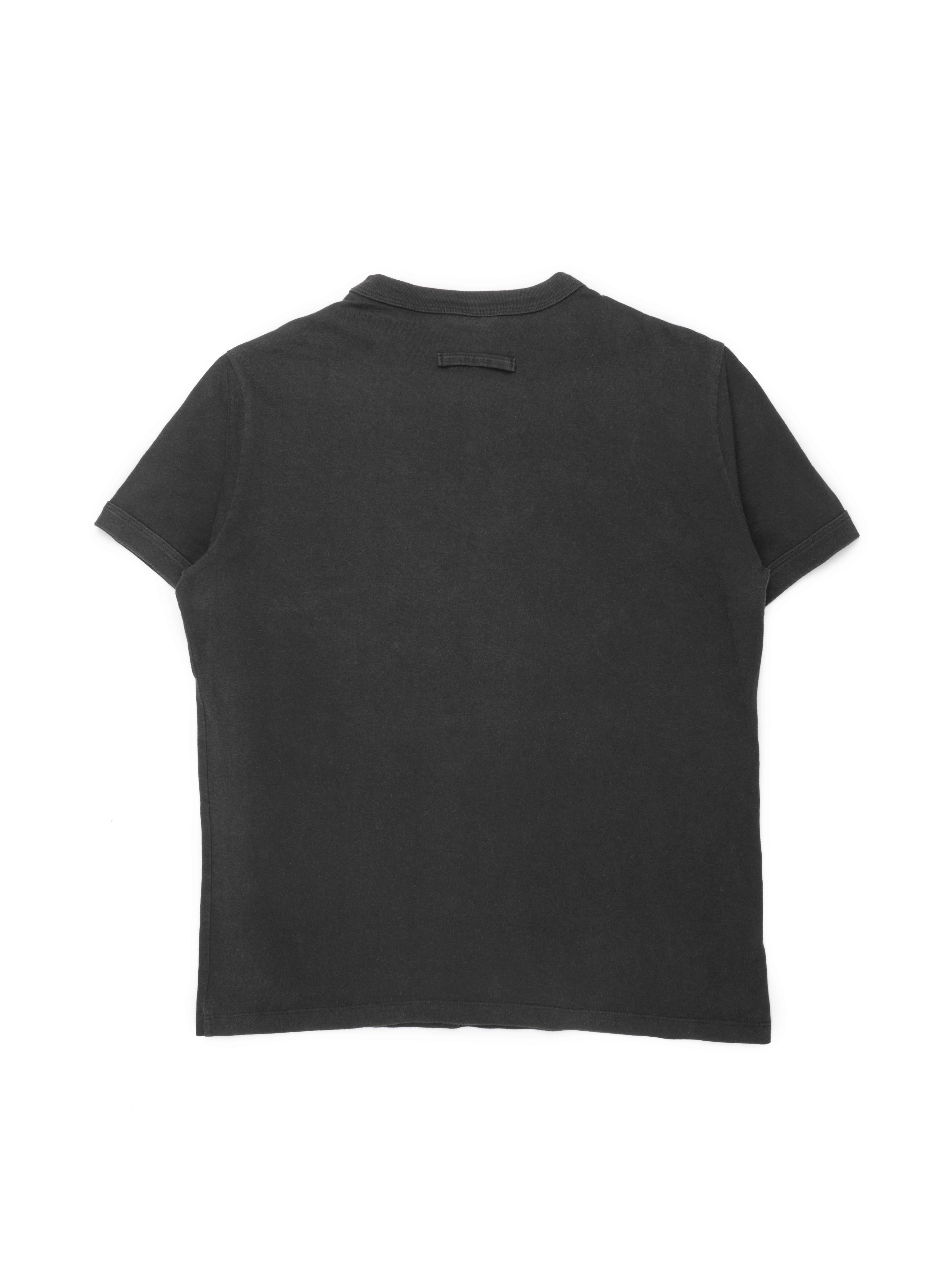 This top contains several of the visual signatures from Jean Paul Gaultier’s spring 2002 collection. The word “Vrai,” French for “true,” could be seen written across a variety of pieces, including tops, jackets, and pants. Layered atop the word is a