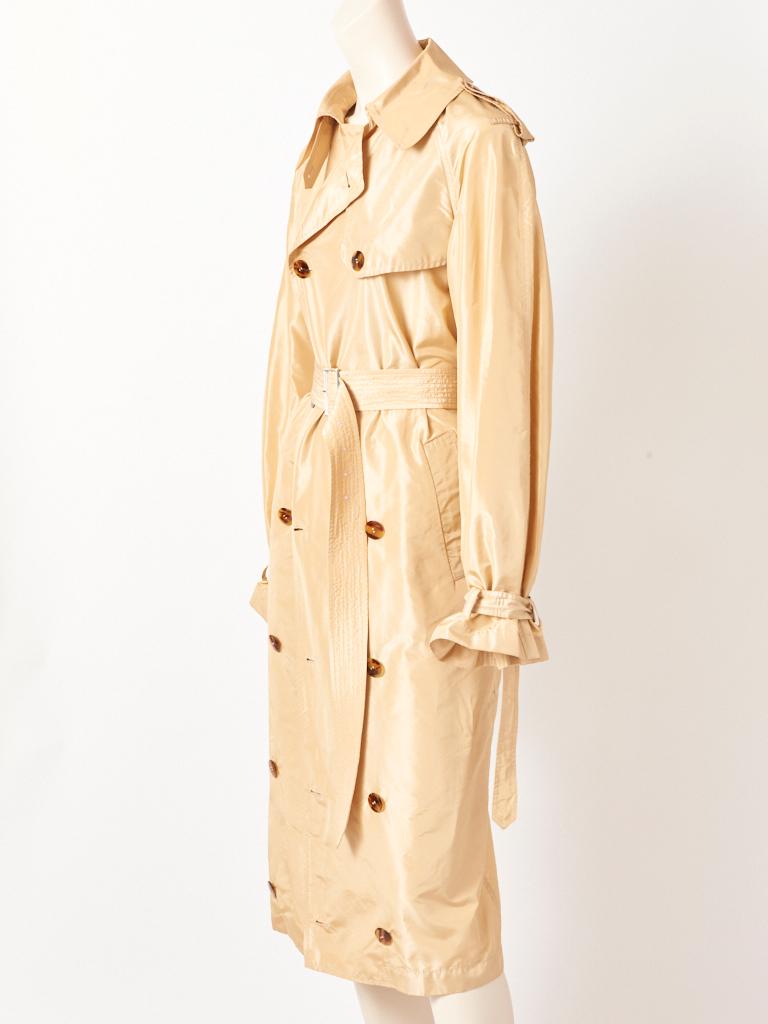 Jean Paul Gaultier, tissue taffeta classic style, double breasted, light beige tone, trench, having a silhouette that narrows. 