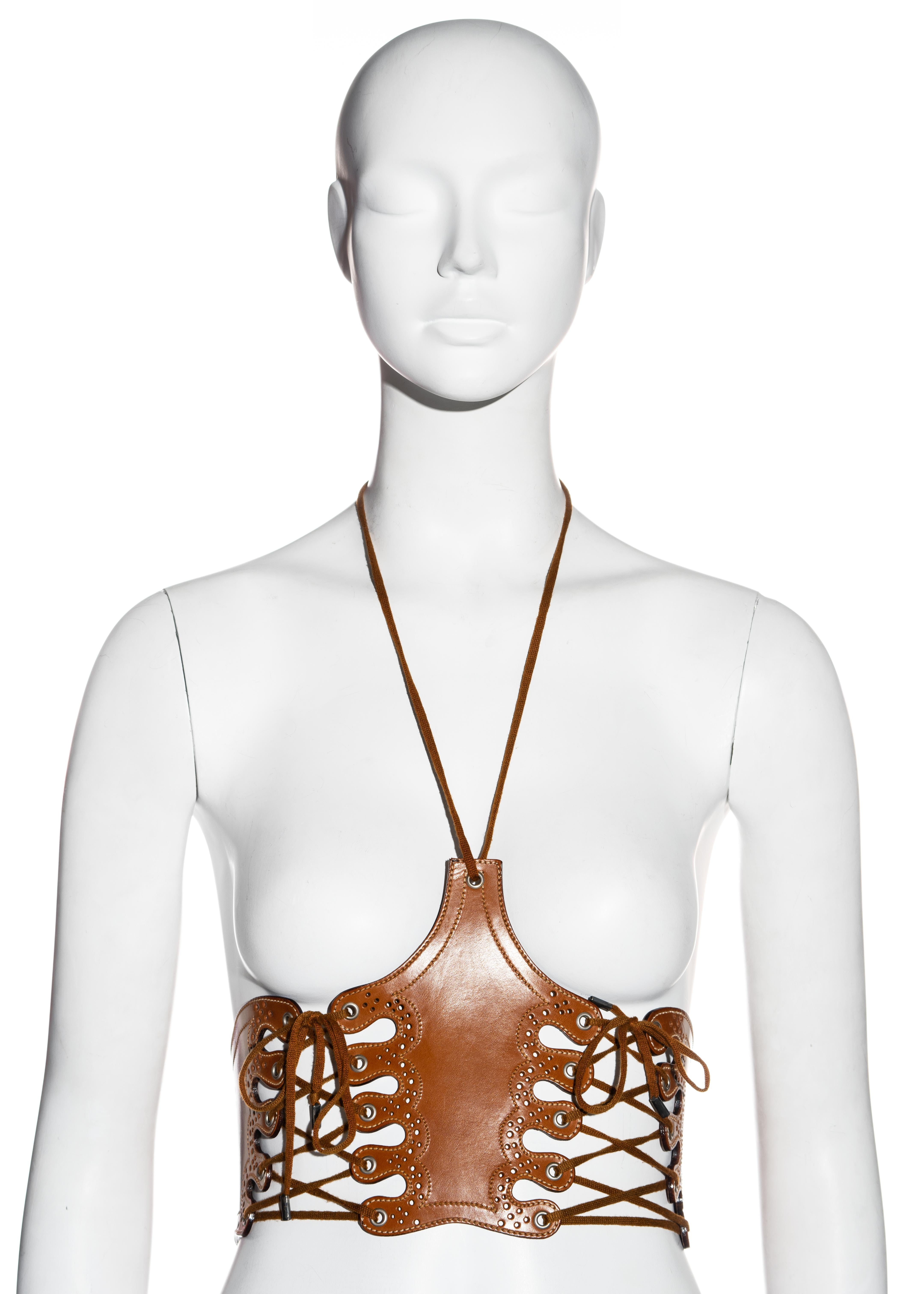 ▪ Jean Paul Gaultier tan leather corset with halter 
▪ Skin baring openings with lacing 
▪ Western-style details 
▪ IT 42 - FR 38 - UK 10 (sizing is flexible)
▪ Spring-Summer 2004