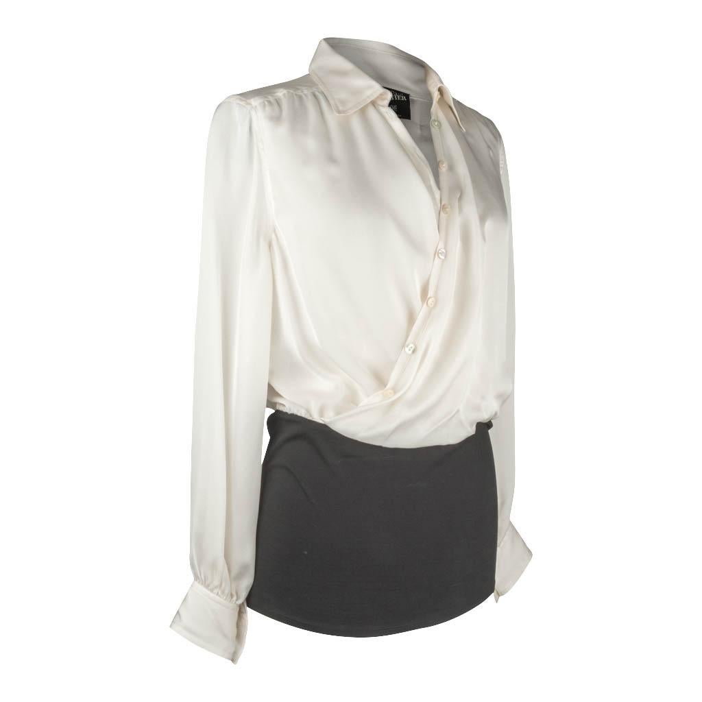 Guaranteed authentic Jean Paul Gaultier winter white top with black cotton stretch at bottom.
Exquisitely detailed silk top with beautiful drape.
Asymmetrically cut to accent drape at elasticized waist.
Black cotton piece at bottom of top is fitted