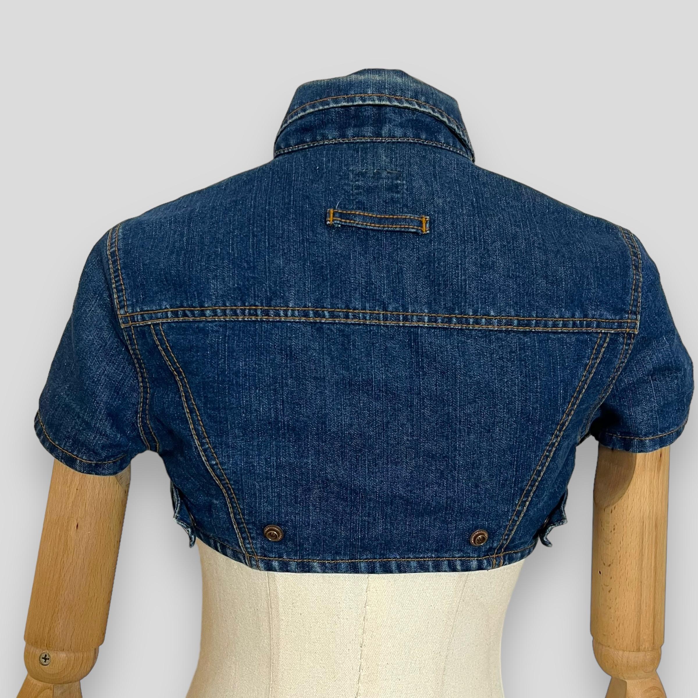 Jean Paul Gaultier ultra cropped denim top  

JEAN PAUL GAULTIER vintage denim crop top, a stunning creation from the iconic French designer renowned for his avant-garde fashion and impeccable craftsmanship. This exquisite jacket showcases a