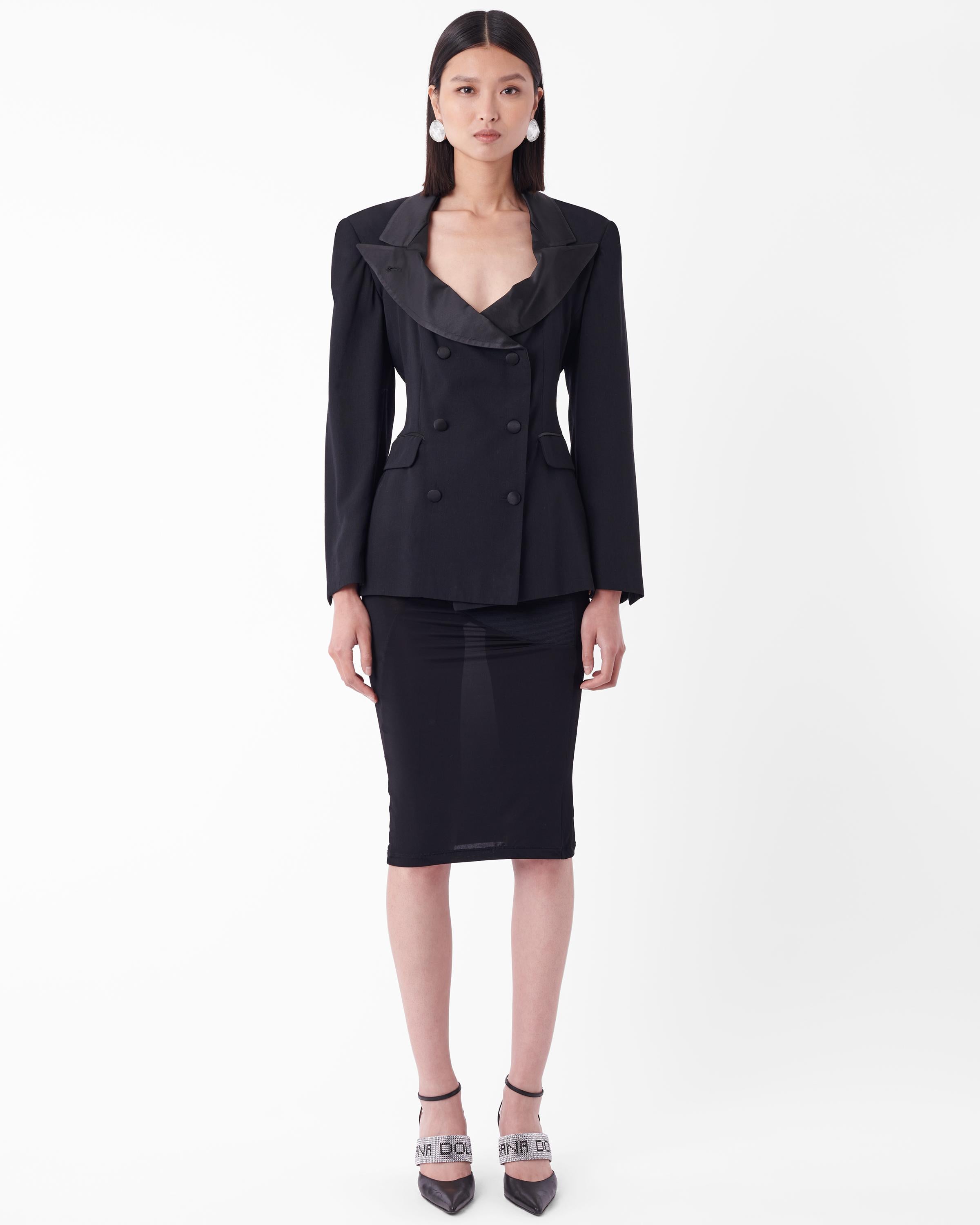 Iconic Jean Paul Gaultier 1988 padded blazer, the navy version was seen on Madonna during her Blonde Ambitions tour. Features satin lapels, buttons and piping and curved silhouette to accentuate waistline with double breasted button closure. In