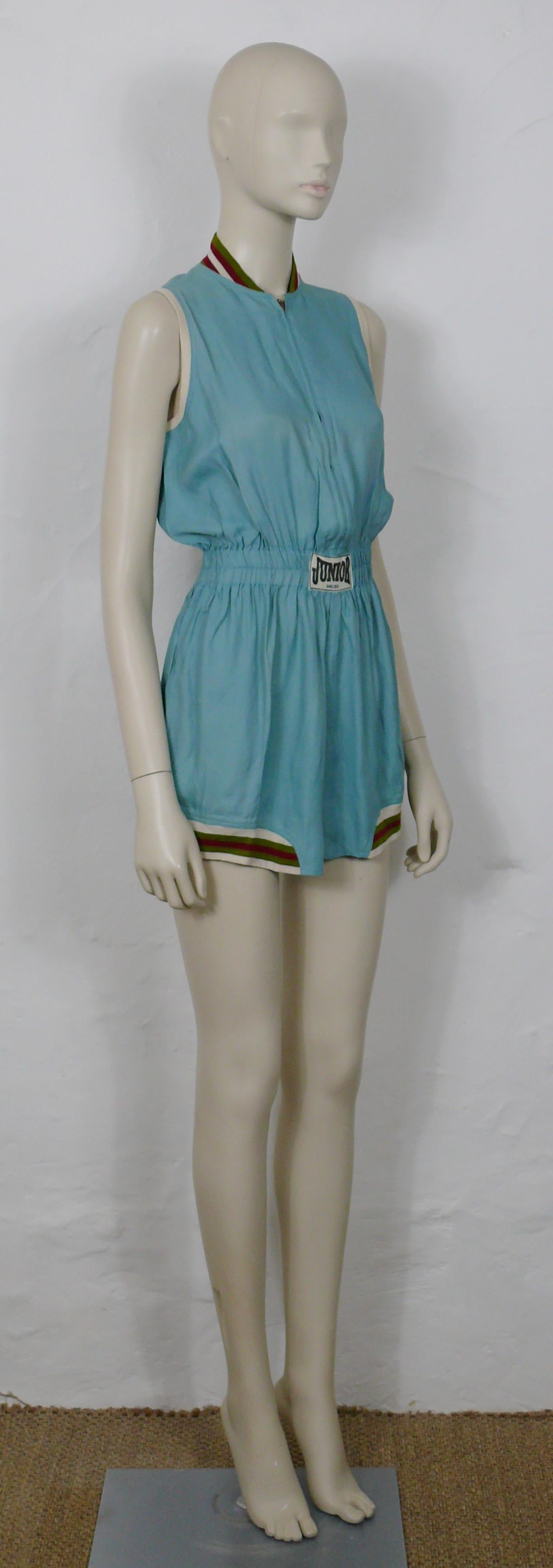 JEAN PAUL GAULTIER vintage rare 1990s turquoise blue shortall inspired by boxing outfits.

This shortall features :
- Turquoise blue viscose with multicolored knitted striped details on collar and thighs.
- Short sleeves.
- Short shorts.
- Elastic