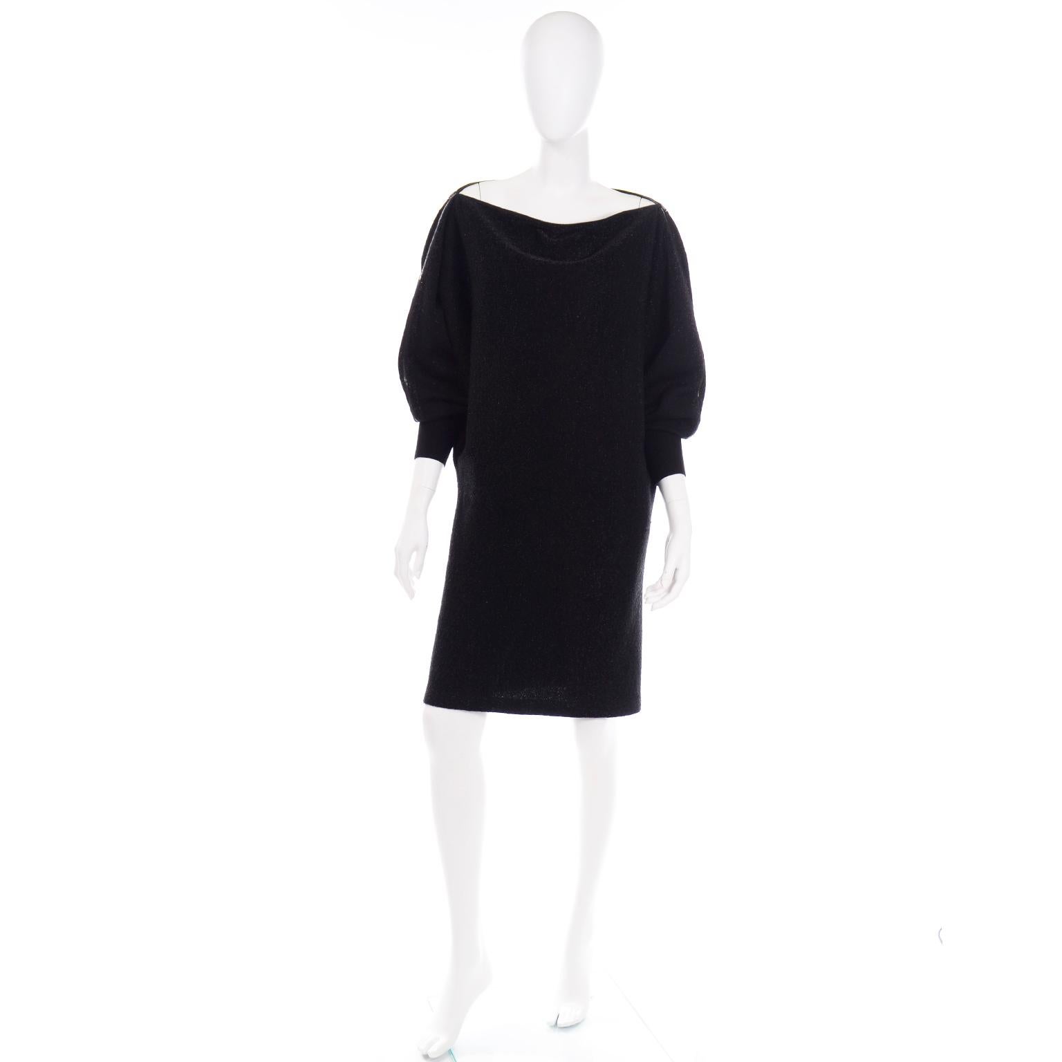This vintage Jean Paul Gaultier black sparkle knit dress has a metal zipper that starts at the base of the cuffs and wraps around the arms, shoulders, and neck opening. The neckline is completely adjustable with the zippers. The sparkle starts to