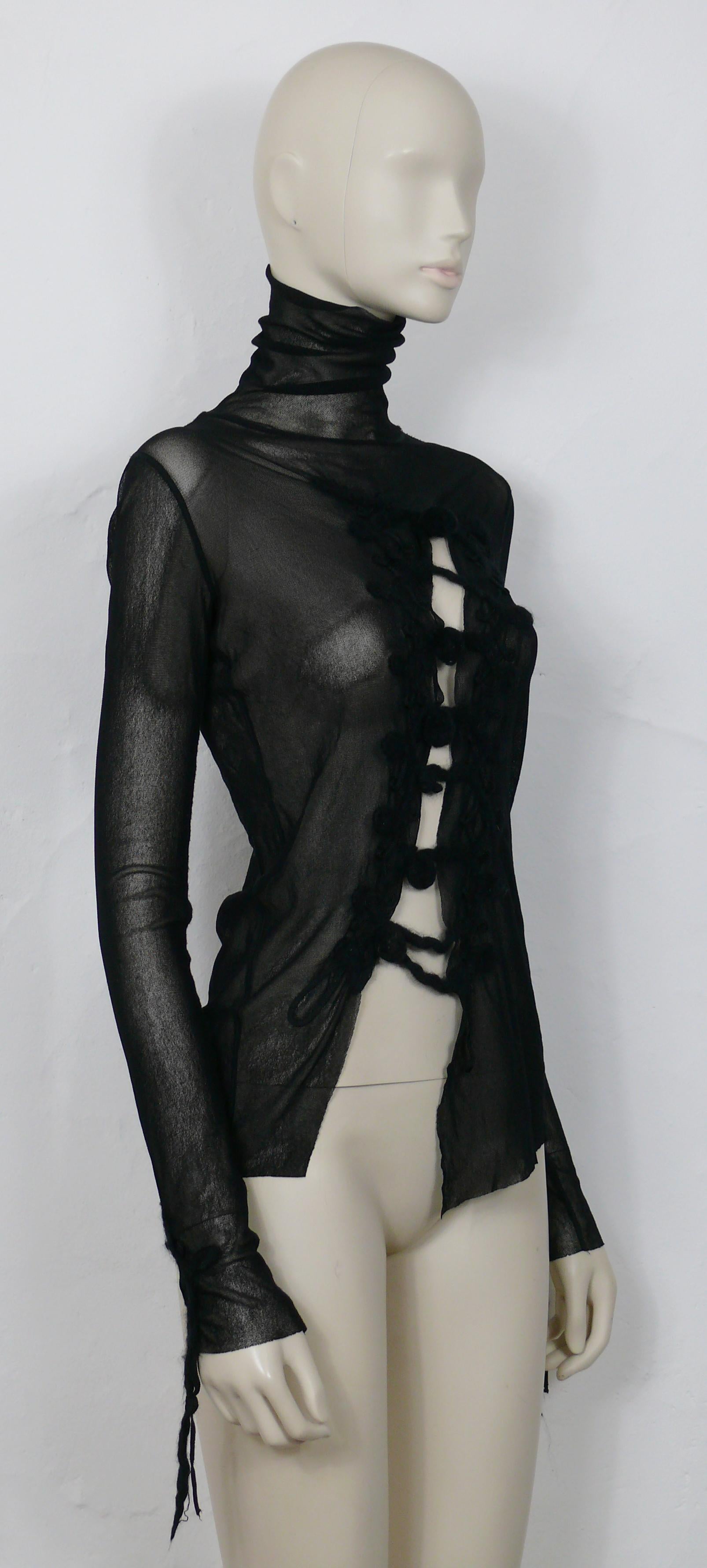 JEAN PAUL GAULTIER vintage black turtleneck top feauturing a bias cut out at the front. Wool and passementerie brandebourg details at the front and on both cuffs.

Label reads JEAN PAUL GAULTIER MAILLE FEMME.
Made in Italy.

Size label reads :