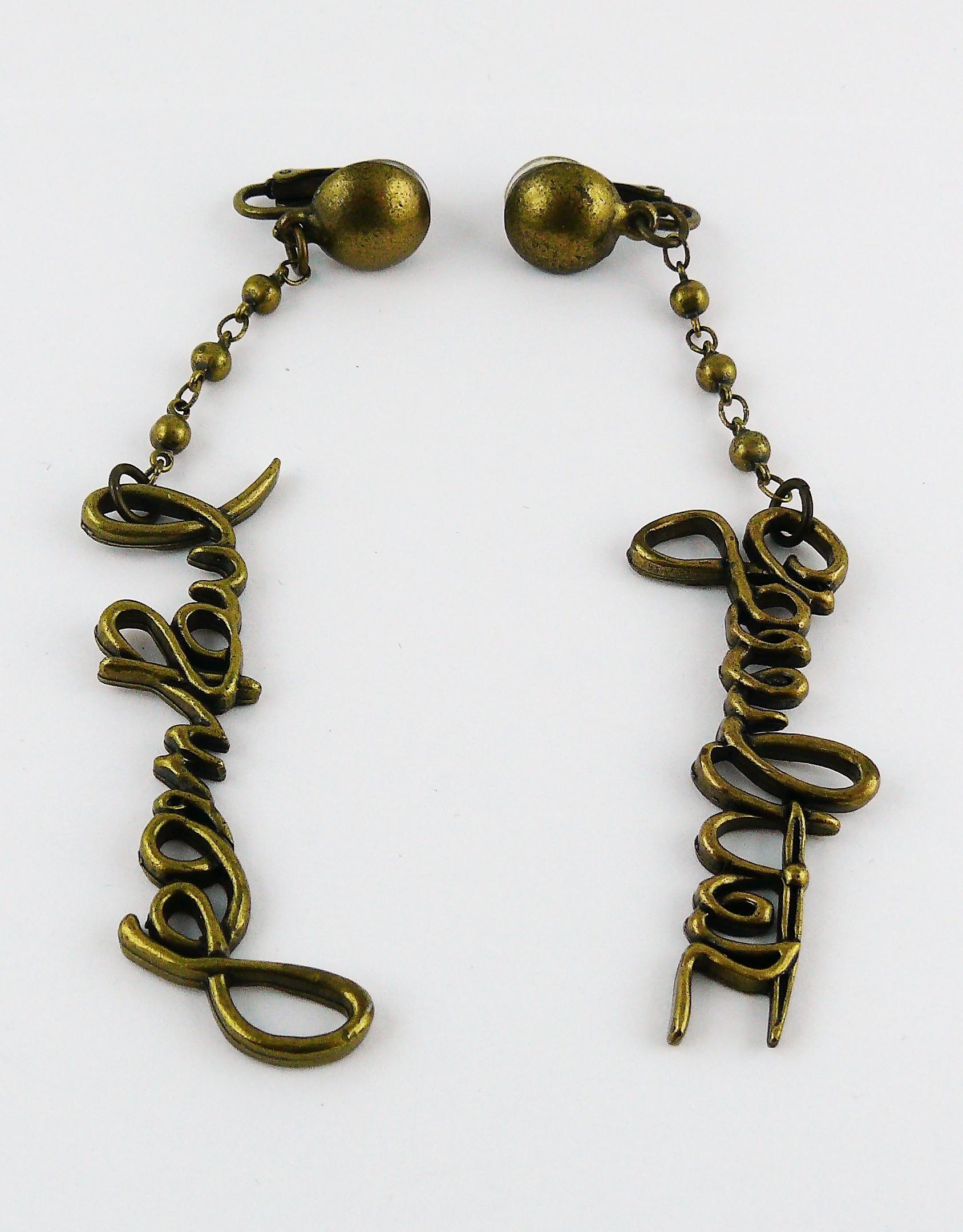 JEAN PAUL GAULTIER vintage antiqued bronze toned dangling earrings (clip-on) featuring cursive signatures JEAN PAUL and GAULTIER.

Marked GAULTIER.

Indicative measurements : length approx. 10 cm (3.94 inches) / max. width approx. 1.4 cm (0.55