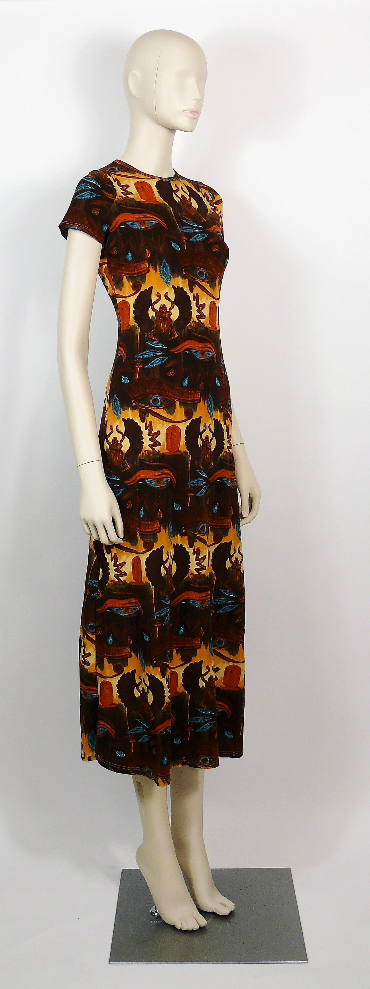 JEAN PAUL GAULTIER vintage dress featuring Egyptian symbols : eyes, scarabs, cartouches and hieroglyphs.

This dress features :
- Stretchy material.
- Round collar.
- Cap sleees.
- Slits on both sides.

Label reads GAULTIER JEAN'S.

Missing