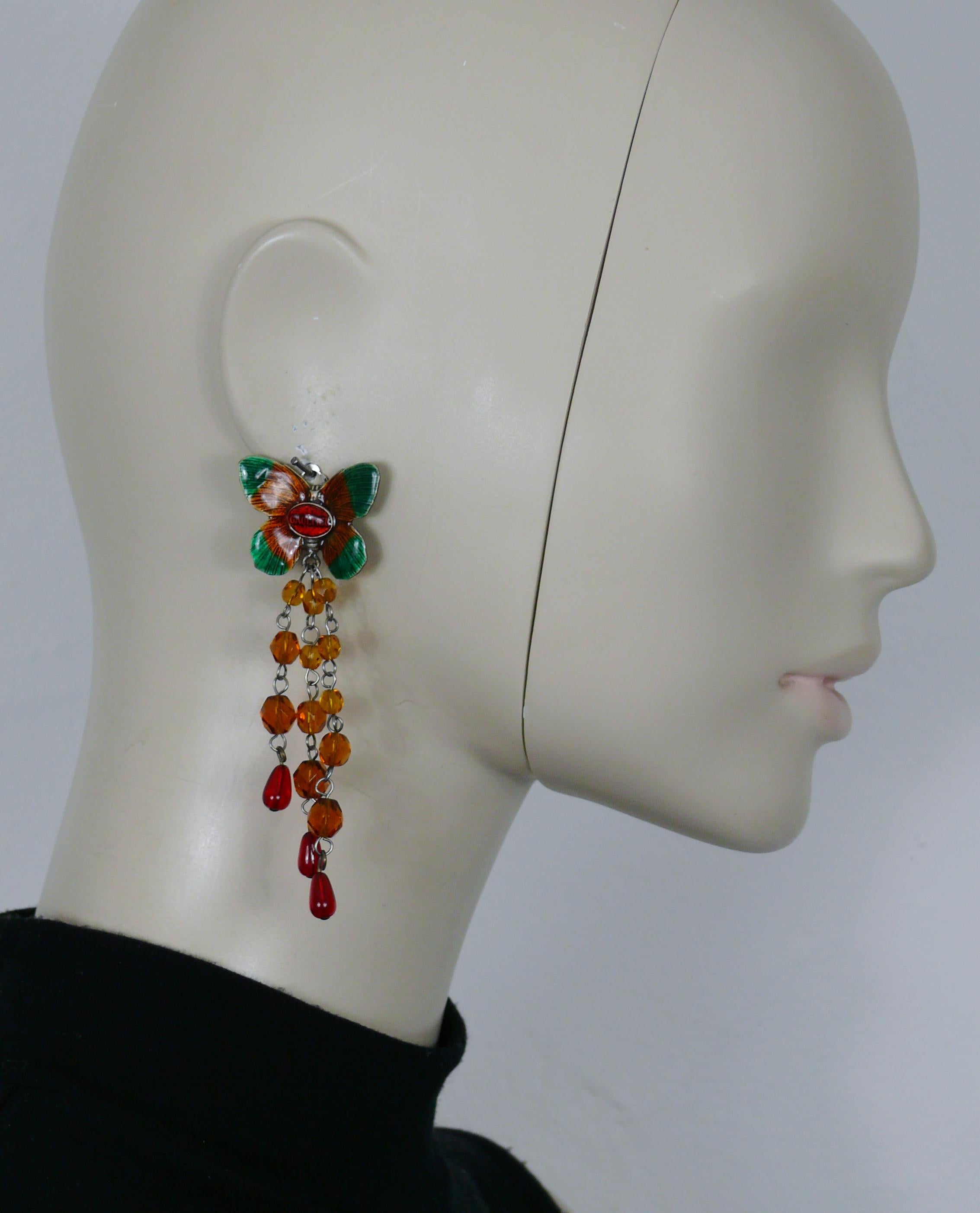 JEAN PAUL GAULTIER vintage enamel butterfly dangling earrings (clip-on) featuring orange faceted glass beads and red drop embellishment.

Marked GAULTIER.

Indicative measurements : max. height approx. 9 cm (3.54 inches) / max. width approx. 3 cm