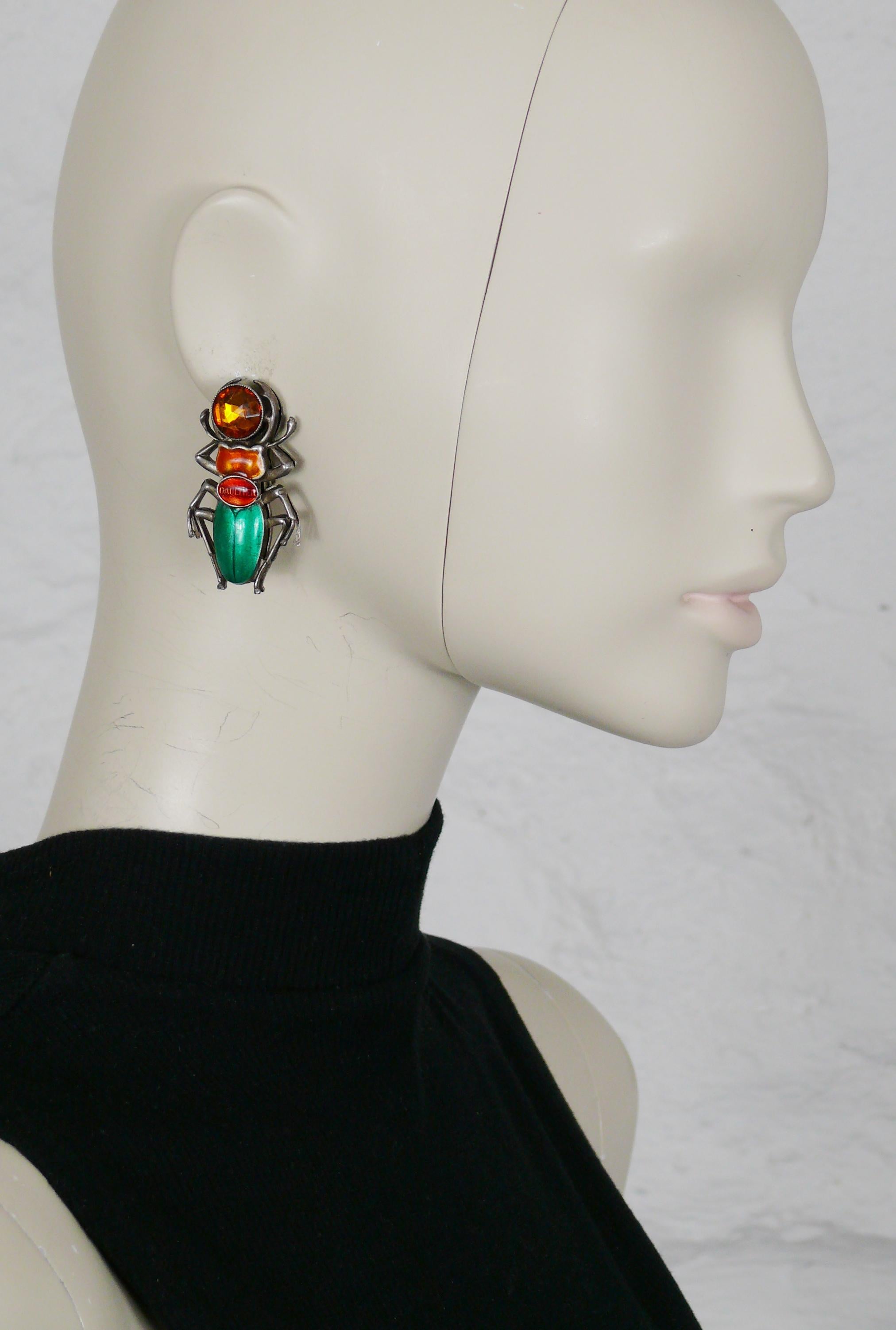 JEAN PAUL GAULTIER vintage antiqued silver toned clip-on earrings featuring an enameled scarab embellished with a citrine color crystal.

Marked GAULTIER.

Indicative measurements : height approx. 4.7 cm (1.85 inches) / max. width approx. 2.5 cm