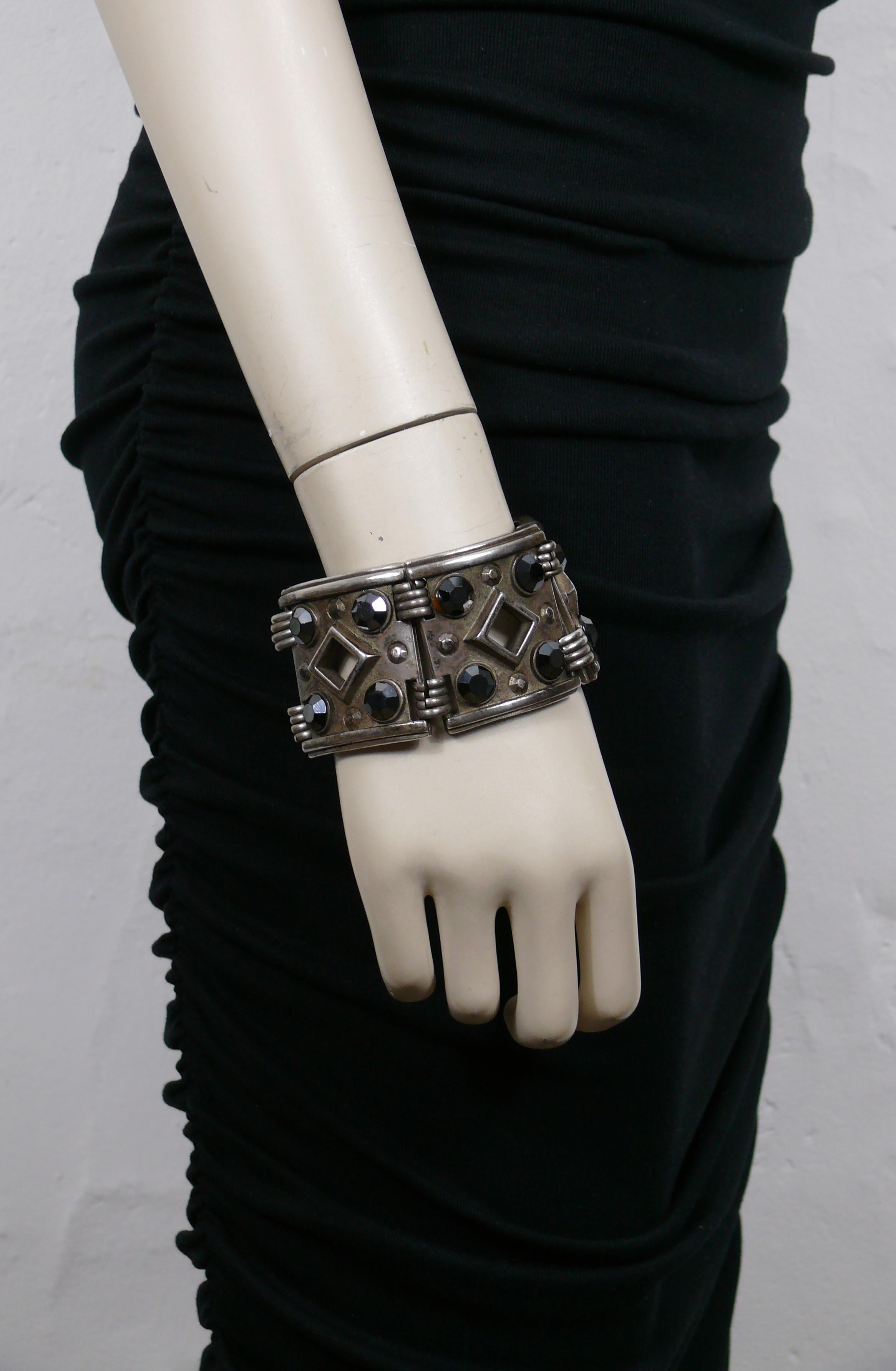 JEAN PAUL GAULTIER vintage antiqued silver tone ethnic cuff bracelet featuring articulated rectangular links embellished with black crystals.

T-bar and toggle closure.

Embossed JPG on the reverse of each link.

Indicative measurements : length