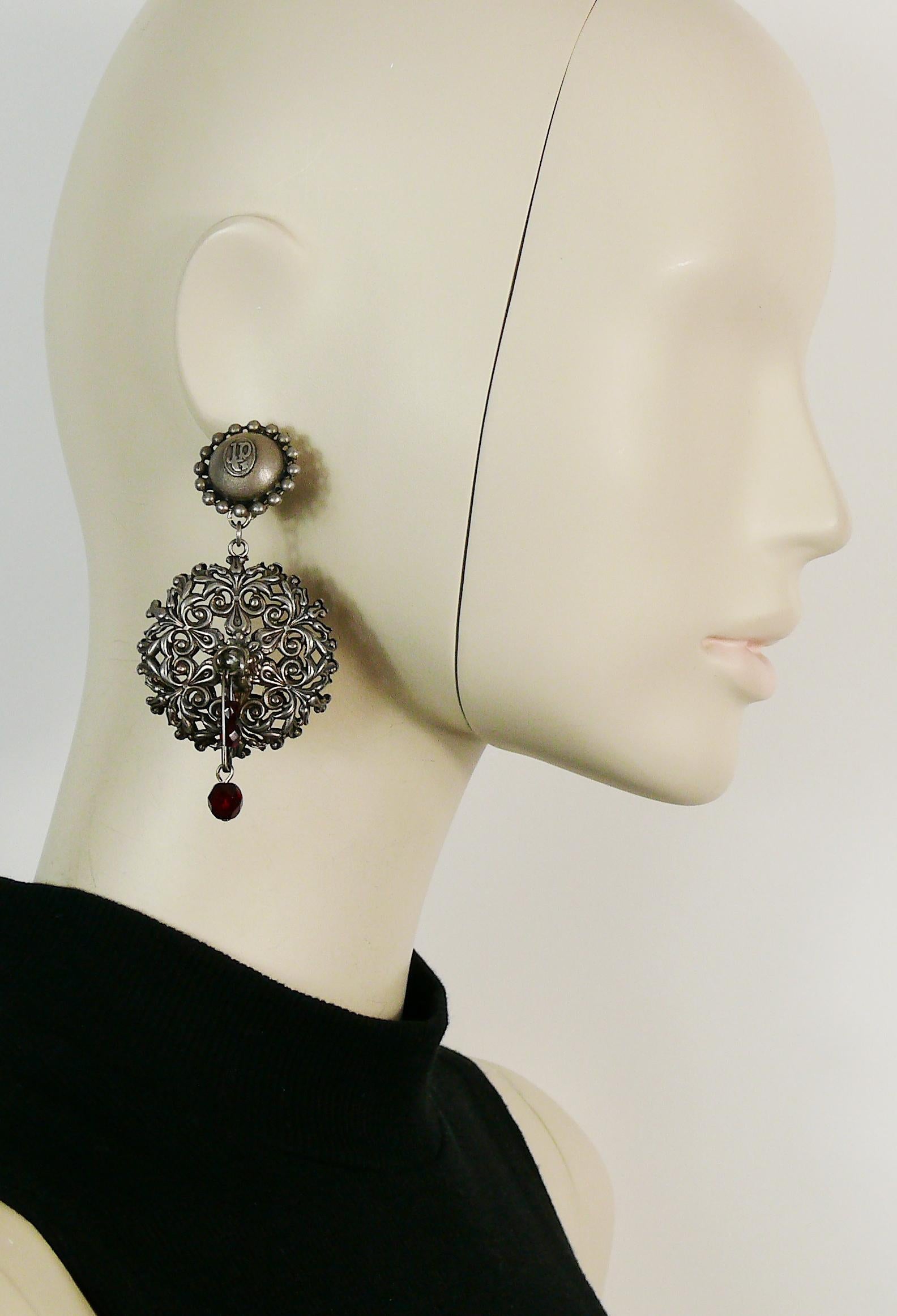 JEAN PAUL GAULTIER vintage antiqued silver toned filigree dangling earrings (clip-on) featuring a safety pin embellished with ruby color beads.

Marked JPG.

Indicative measurements : max. height (including bead drop) approx. 9 cm (3.54 inches) /