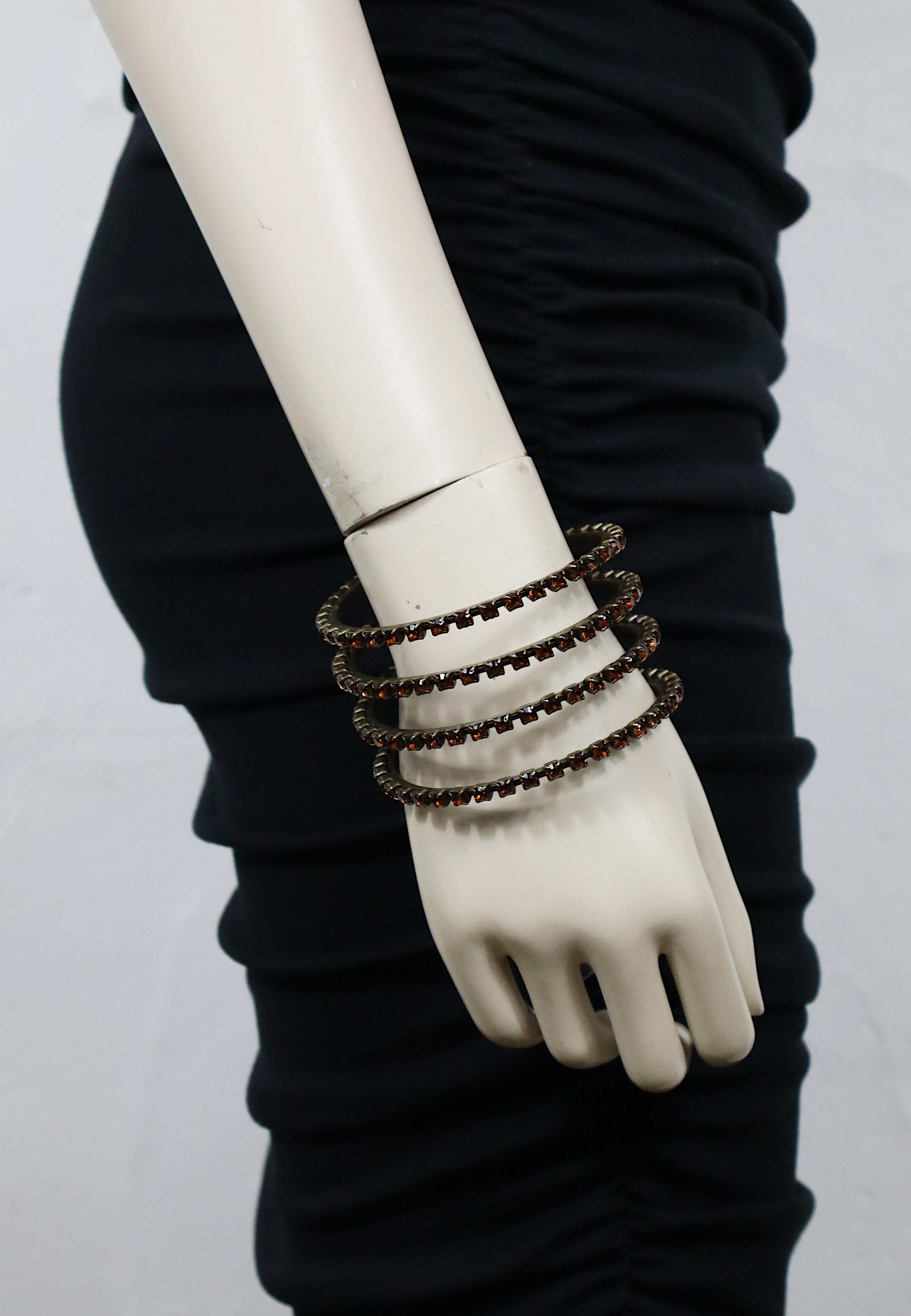 JEAN PAUL GAULTIER vintage antiqued bronze tone metal coil cuff bracelet embellished with citrine color crystals.

Slips on (no clasp closure).

Marked GAULTIER.

Indicative measurements : inner circumference approx. 20.42 cm (8.04 inches) / width