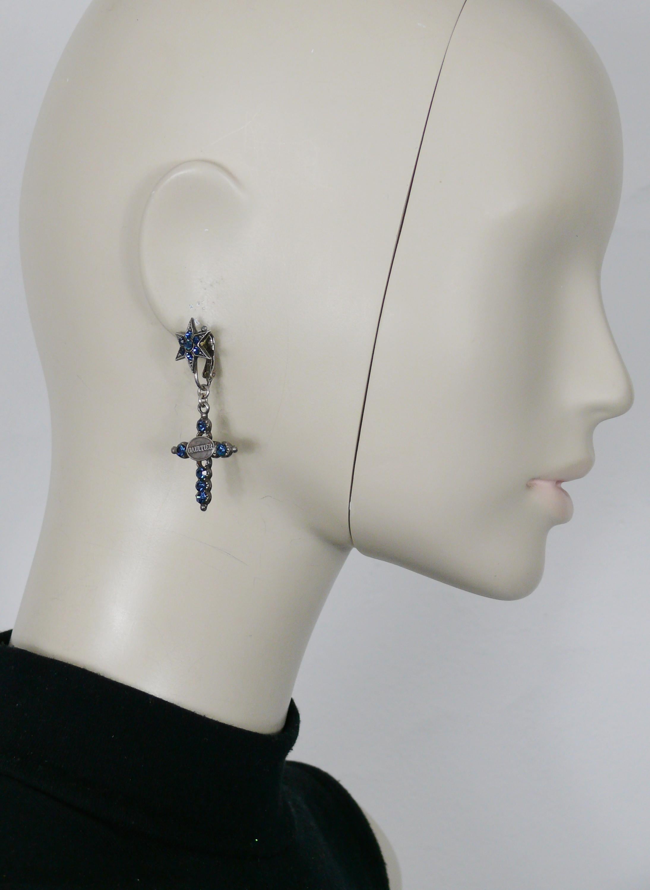 JEAN PAUL GAULTIER  vintage gun patina dangling earrings (clip-on) featuring a cross topped by a star embellished with blue crystals.

Marked GAULTIER.

Indicative measurements : max. height approx. 5.5 cm (2.17 inches) / max. width approx. 2 cm