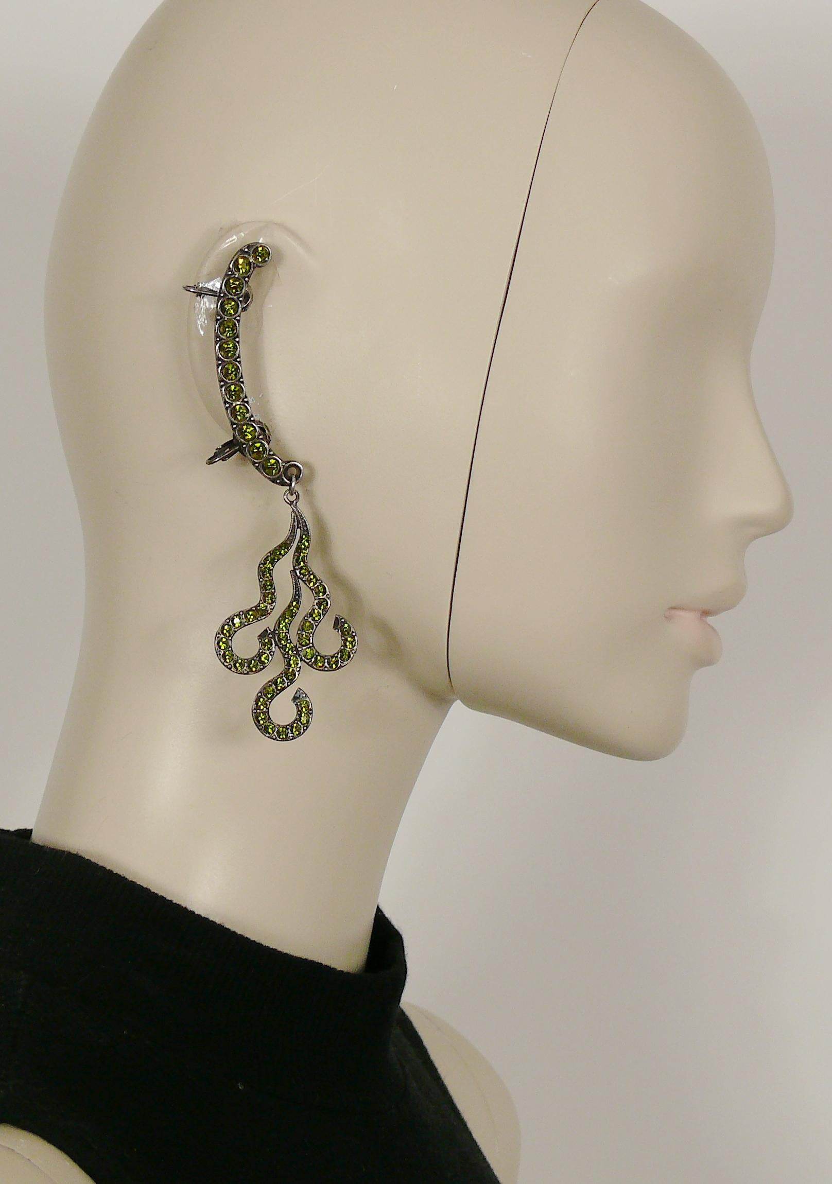 JEAN PAUL GAULTIER vintage rare antiqued silver toned ear cuffs embellished with green olivine crystals and featuring a stylized flame pendant.

Marked GAULTIER.

Indicative measurements : max. length approx. 11.5 cm (4.53 inches).

NOTES
- This is