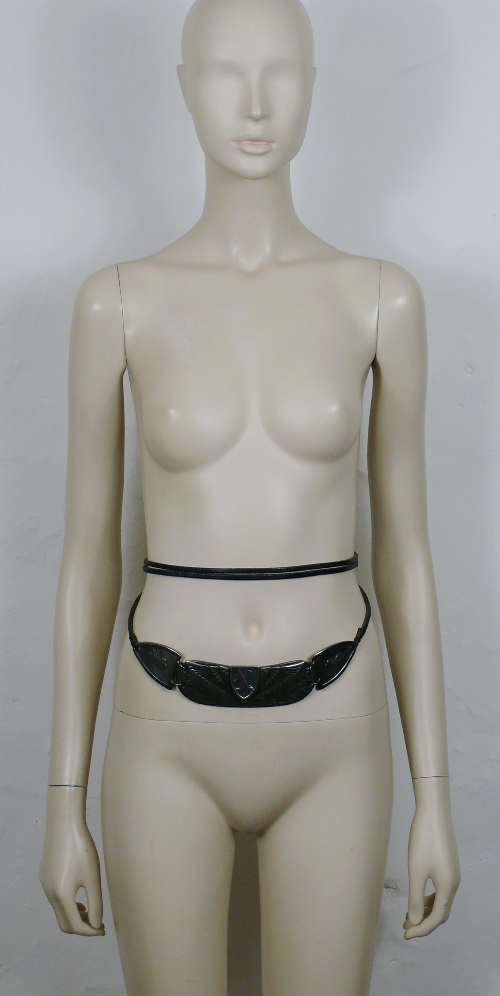 JEAN PAUL GAULTIER vintage gun tone metal 3-D buckle moto belt featuring JEAN PAUL GAULTIER profile ,sewing attributes and mannequins.

Black leather straps.
Ties around the waist.
One size fits all.

Limited edition belt edited on the occasion of