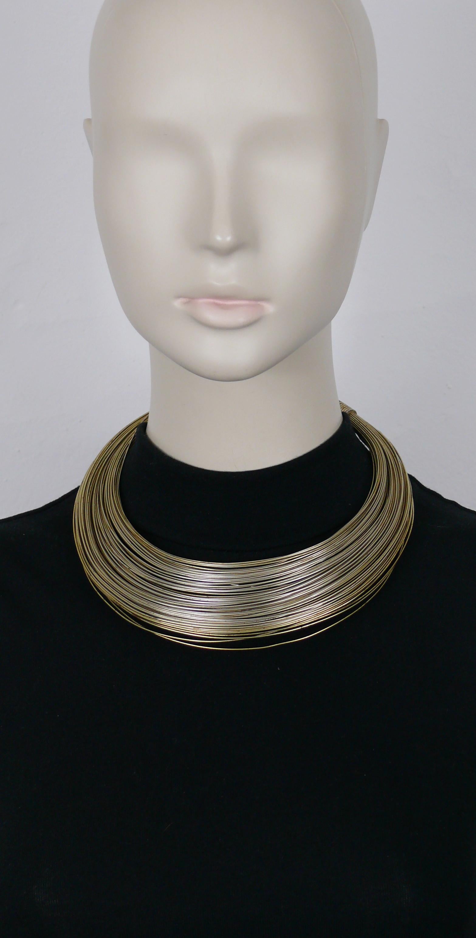 JEAN PAUL GAULTIER vintage Masai light gold tone multi wire choker necklace.

Adjustable hook clasp closure.

Marked GAULTIER.

Indicative measurements : minimum inner circumference approx. 39.27 cm (15.46 inches) - expandable to larger
