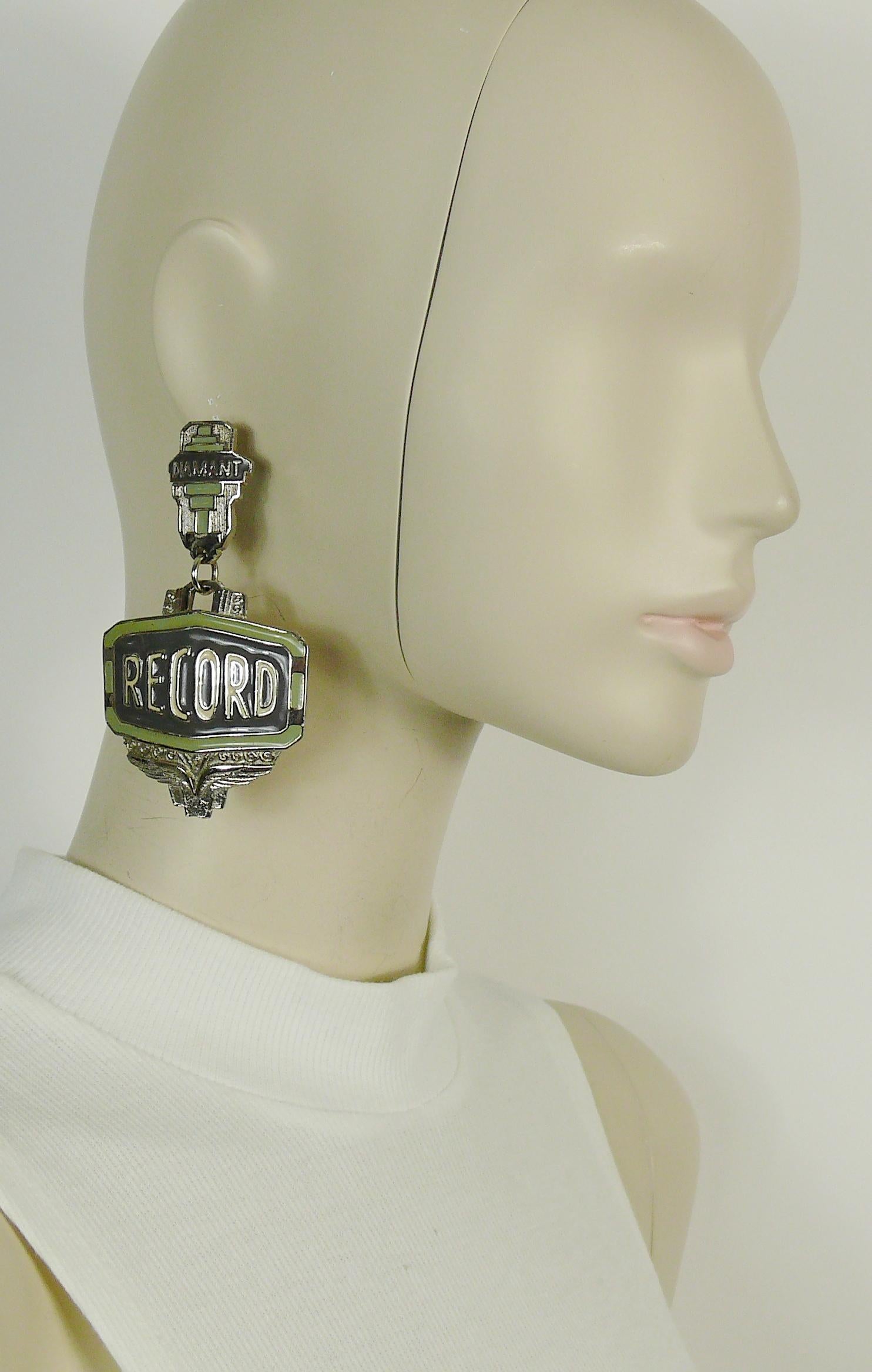 JEAN PAUL GAULTIER vintage massive silver toned metal dangling earrings (clip on) featuring an Art Deco inspired design with green/grey/off white overlay and DIAMANT-RECORD inscriptions.

Marked JPG.

Indicative measurements : length approx. 9.3 cm