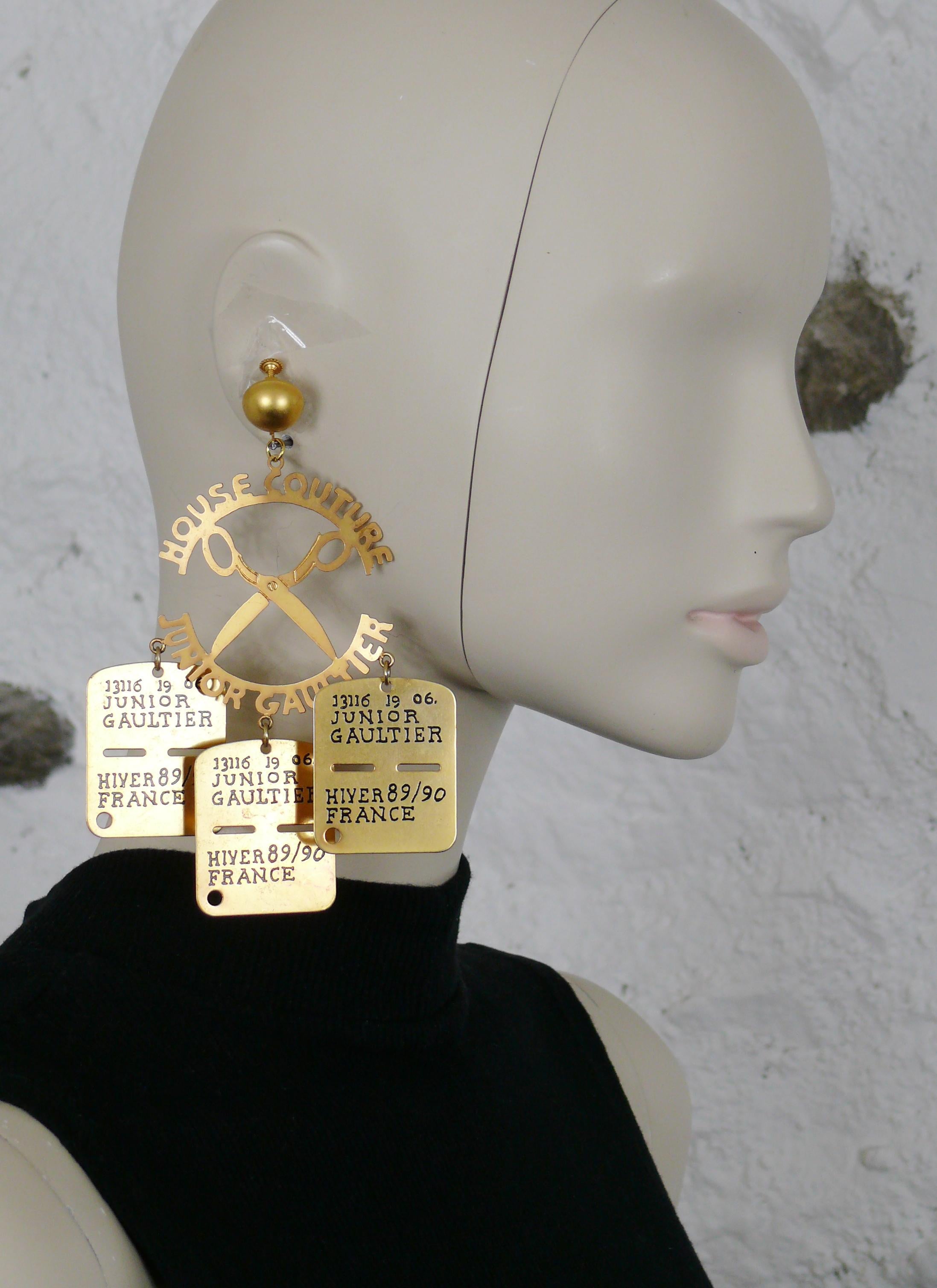 JEAN PAUL GAULTIER vintage rare massive gold toned mobile dangling earrings (clip-on with screw adjustment system) featuring a large round cut-out advertising sign HOUSE COUTURE JUNIOR GAULTIER and 3 plates charms embossed with numbers, JUNIOR